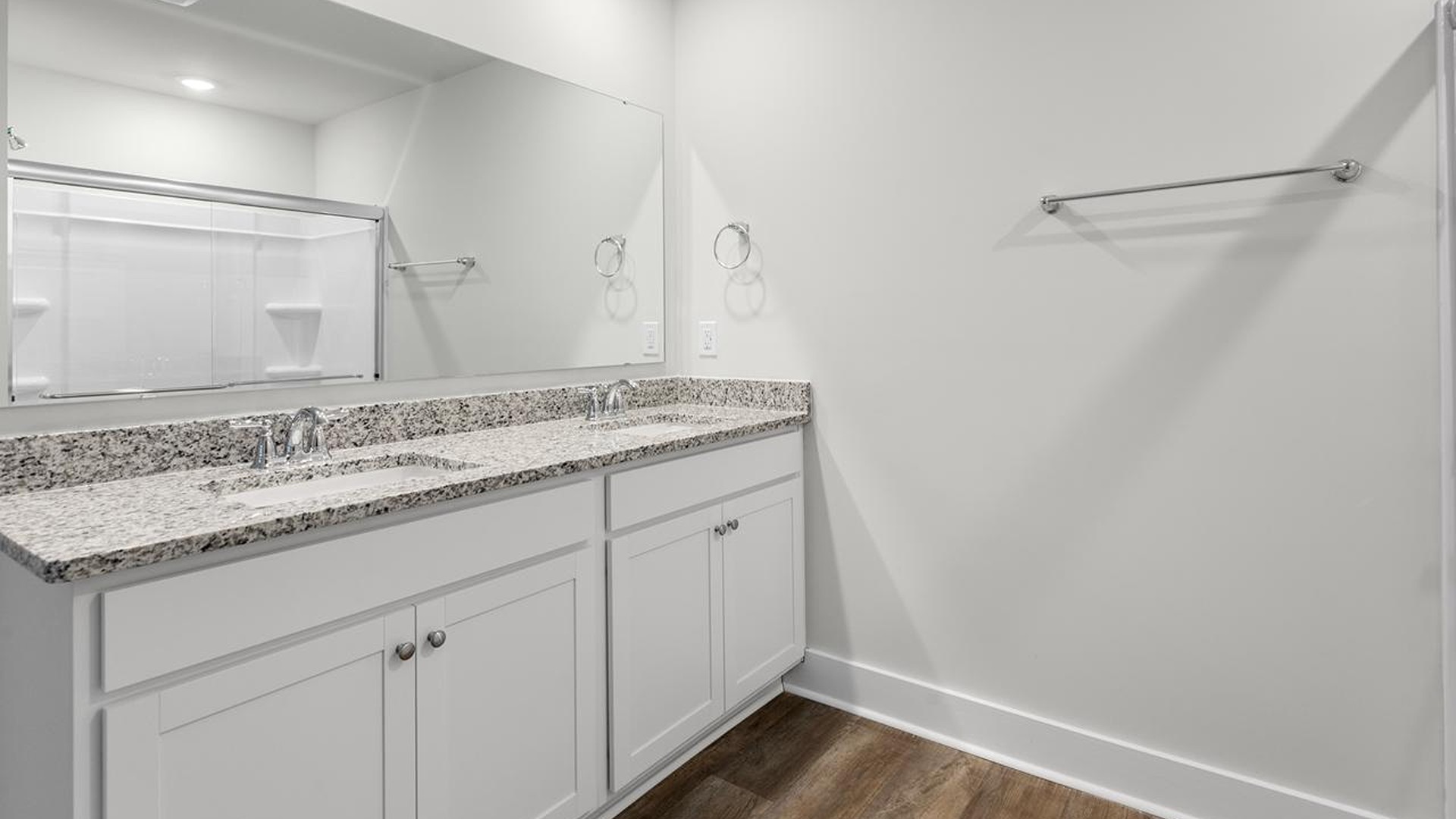 The primary suite offers a massive closet and a luxurious bathroom with a walk-in shower, linen closet, and dual vanity.