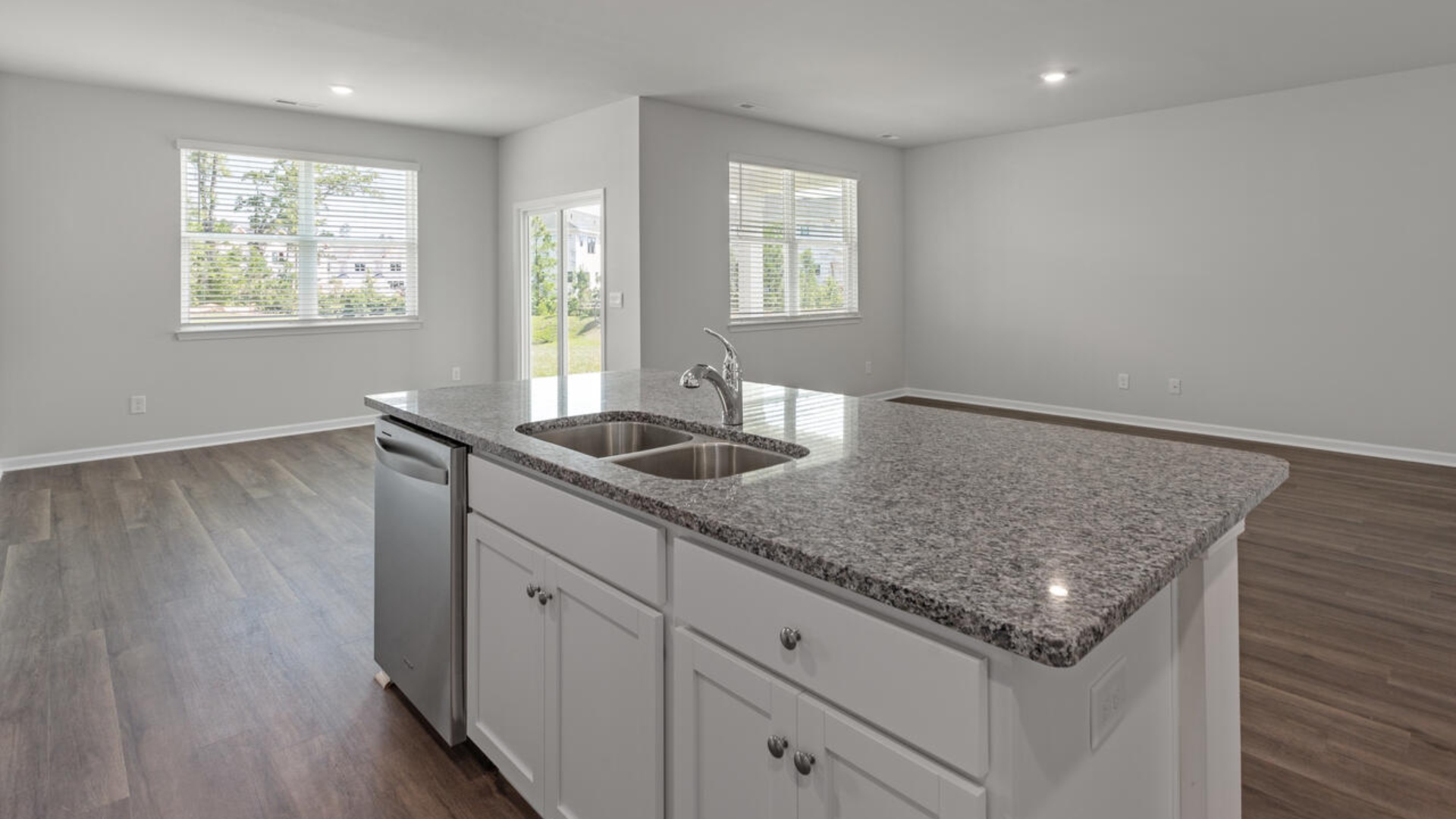 The kitchen features a large island, granite countertops, and stainless steel appliances, which are sure to both turn heads and make meal prep easy