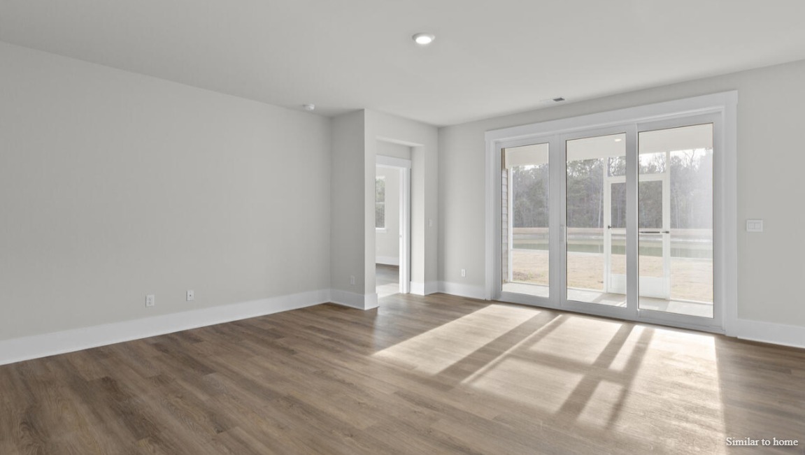 Enjoy coastal living at its best with a screened-in covered porch just off the open-concept kitchen, dining, and living areas — perfect for relaxing or entertaining.