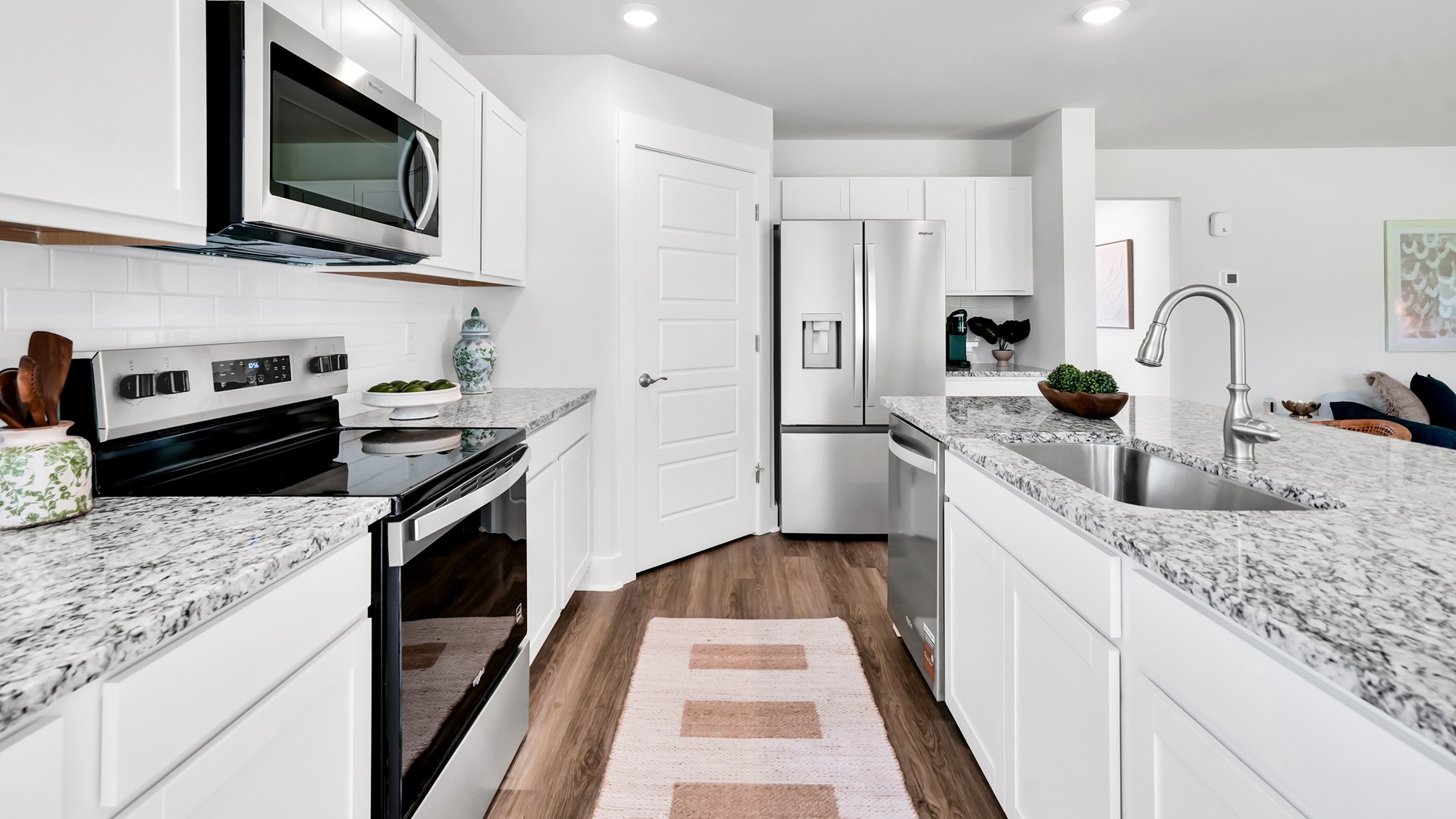Enjoy coastal living at its best with a screened-in covered porch just off the open-concept kitchen, dining, and living areas — perfect for relaxing or entertaining. The kitchen boasts stainless steel appliances, a walk-in pantry, and a generous island that flows seamlessly into the main living area.