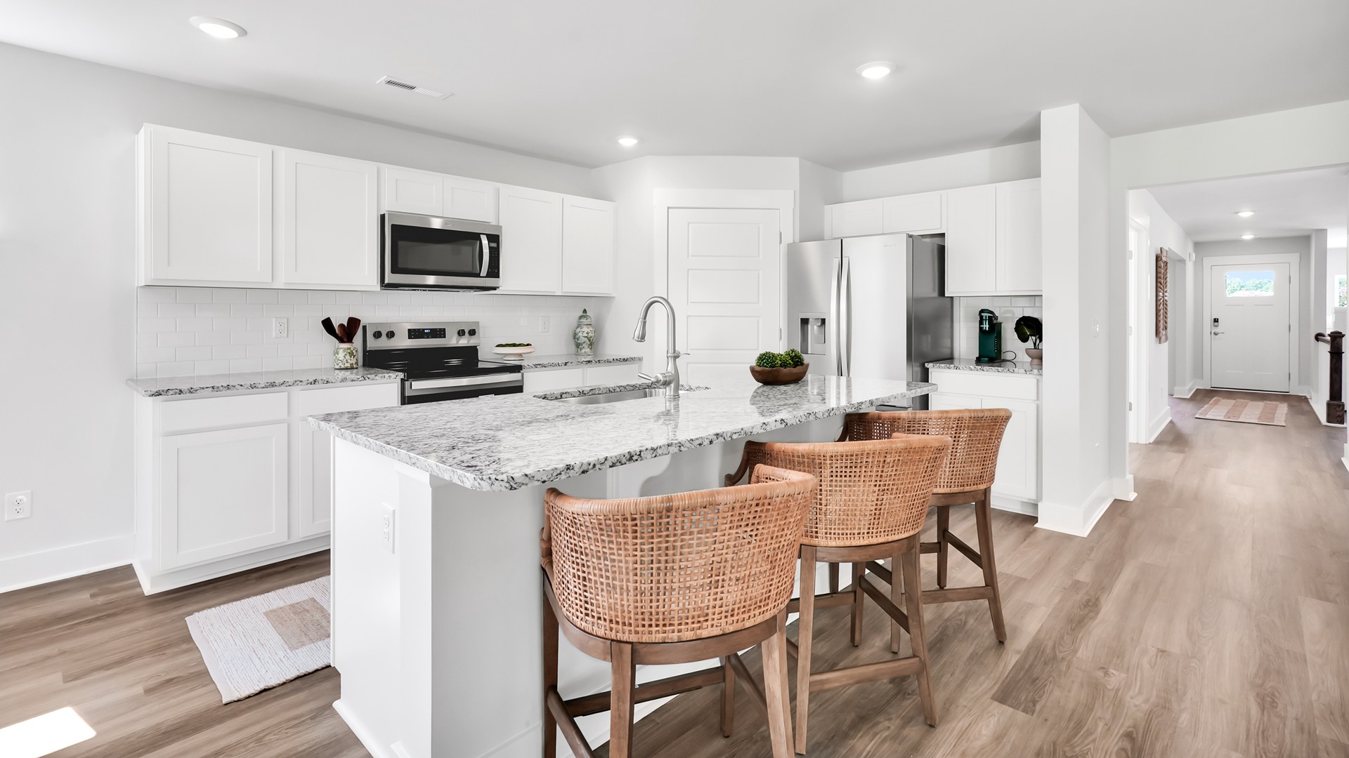 Enjoy coastal living at its best with a screened-in covered porch just off the open-concept kitchen, dining, and living areas — perfect for relaxing or entertaining. The kitchen boasts stainless steel appliances, a walk-in pantry, and a generous island that flows seamlessly into the main living area.