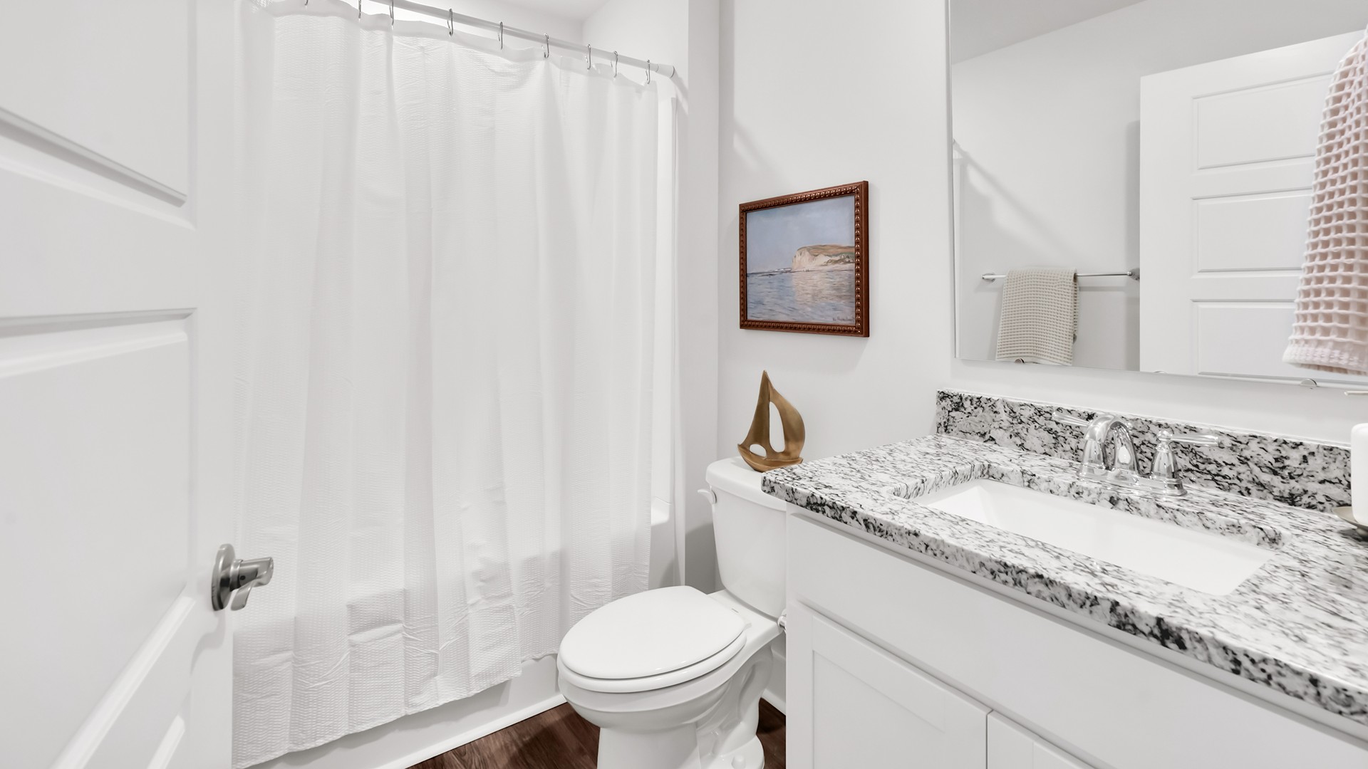 Your primary suite features a 5-foot tiled shower with a frameless glass door and dual vanities for a touch of everyday luxury