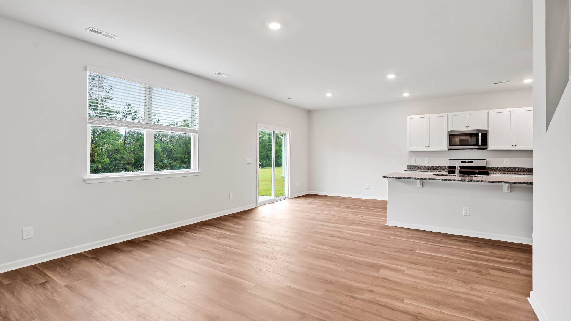 The kitchen seamlessly connects to the dining and living areas, creating a great space for entertainment. Downstairs, a flex room can be used as an office or sitting area