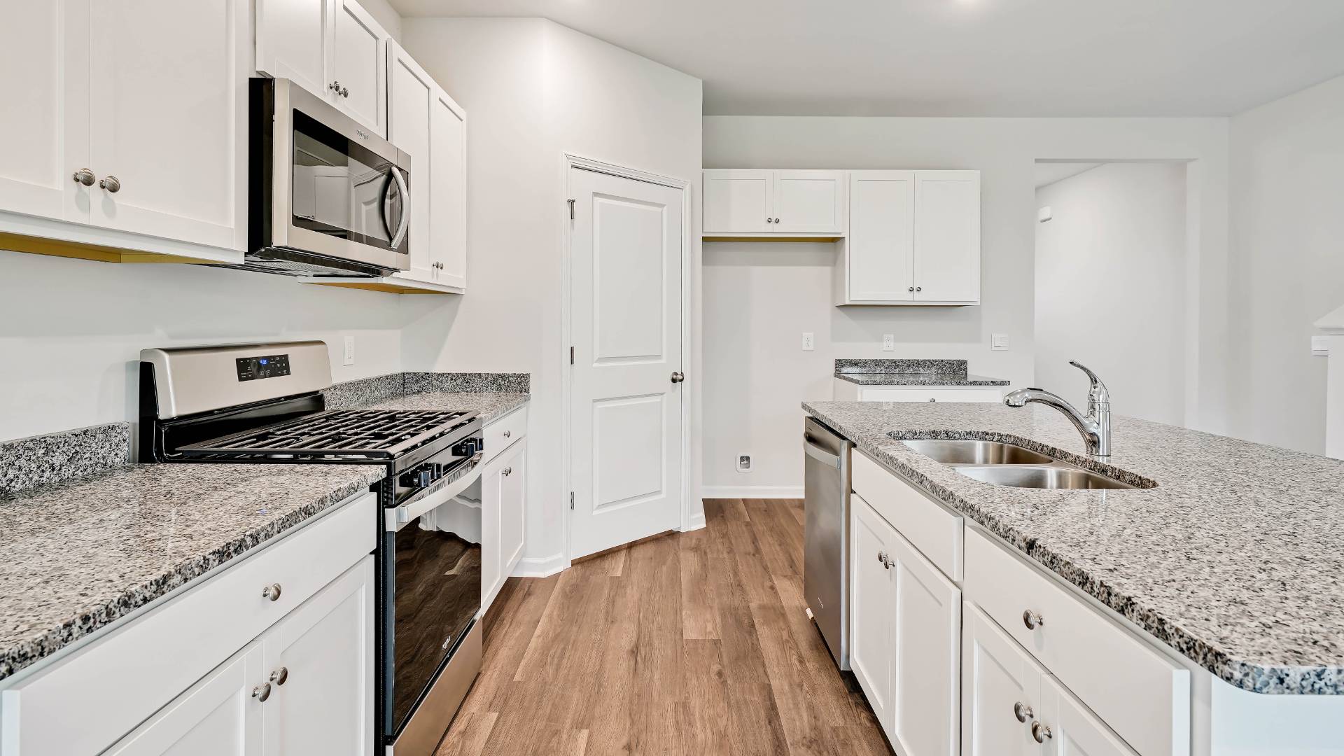 The open-concept kitchen features granite countertops and stainless steel appliances. The kitchen seamlessly connects to the dining and living areas, creating a great space for entertainment. Downstairs, a flex room can be used as an office or sitting area.