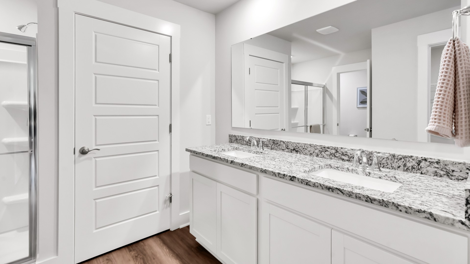 he main level is designed for both functionality and social gatherings, starting with a covered porch that leads into a foyer. From the foyer, you can access a two-car garage and a half bath