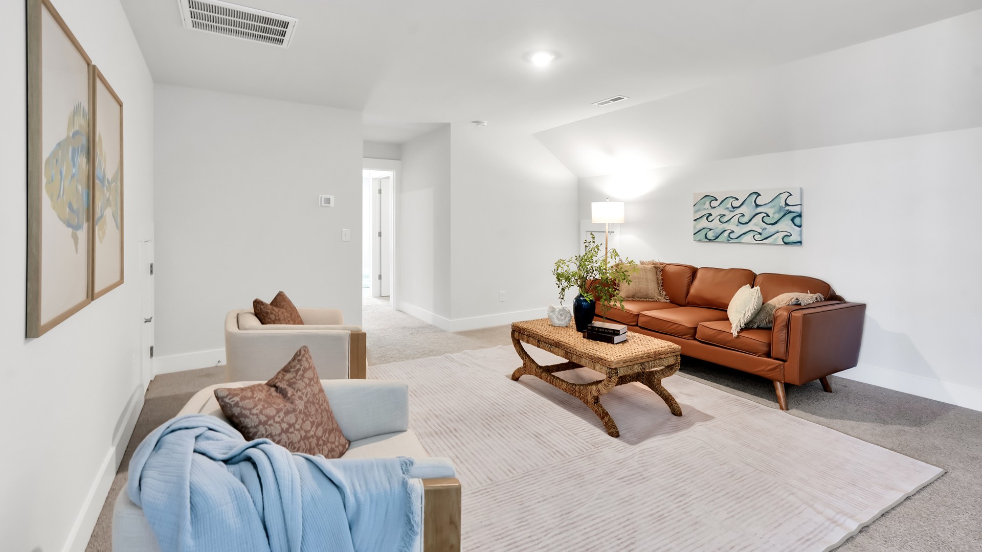 The Guilford second story provides a private living area separate from the main floor, which includes a large upstairs living room, the Primary Bedroom suite, and three additional bedrooms with shared access to bathrooms and laundry facilities. The flooring is a mix of carpet in the bedrooms and vinyl flooring in the laundry room and bathrooms. A full bathroom is conveniently accessible by all three secondary bedrooms.
