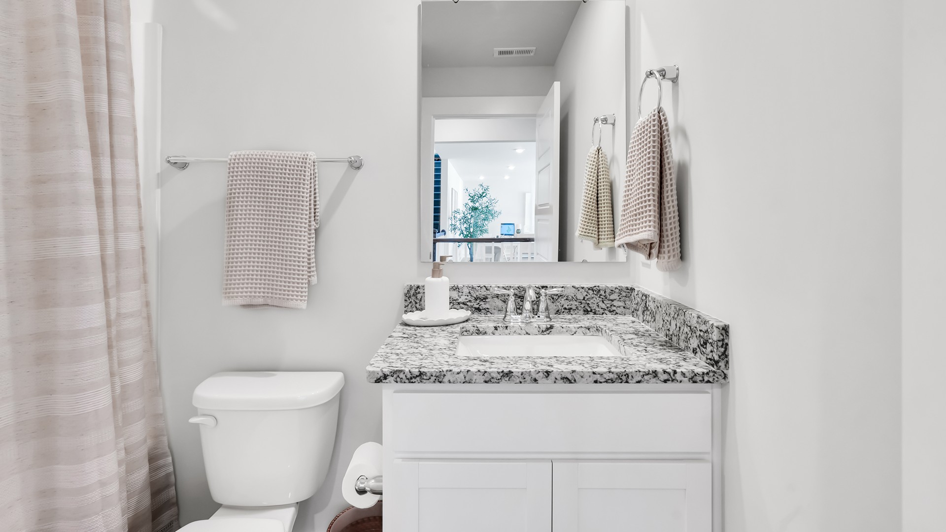 he main level is designed for both functionality and social gatherings, starting with a covered porch that leads into a foyer. From the foyer, you can access a two-car garage and a half bath