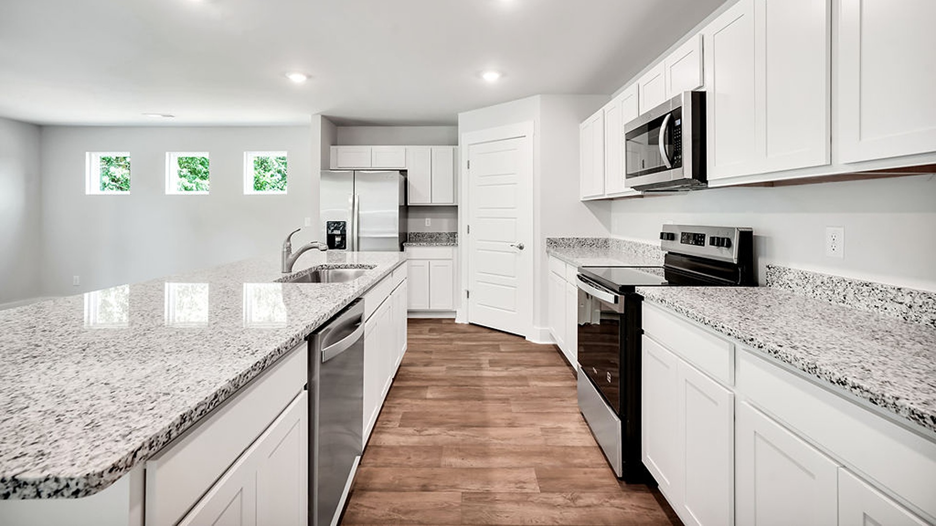 The kitchen features a chef's island, stainless steel appliances, granite countertops, and a spacious walk-in pantry. The kitchen island is the perfect size for meal prep with a built-in sink and dishwasher
