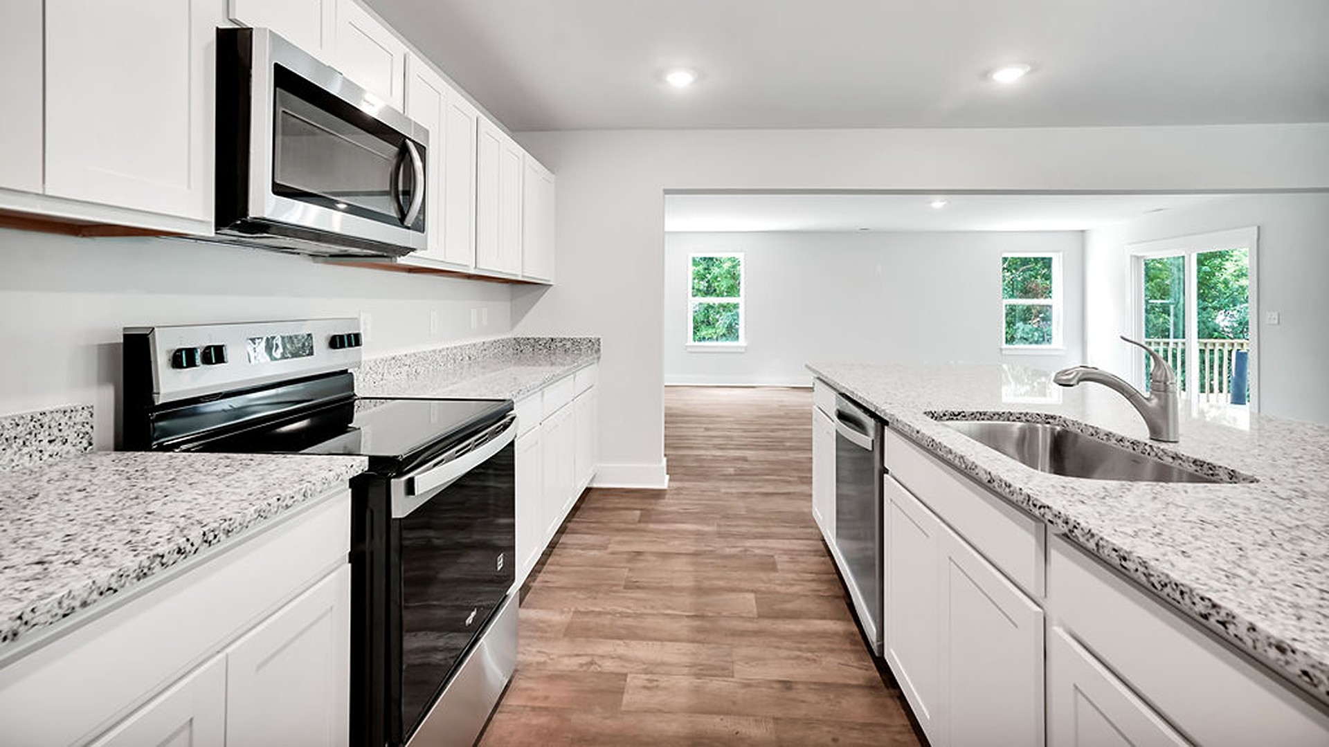 The kitchen features a chef's island, stainless steel appliances, granite countertops, and a spacious walk-in pantry. The kitchen island is the perfect size for meal prep with a built-in sink and dishwasher