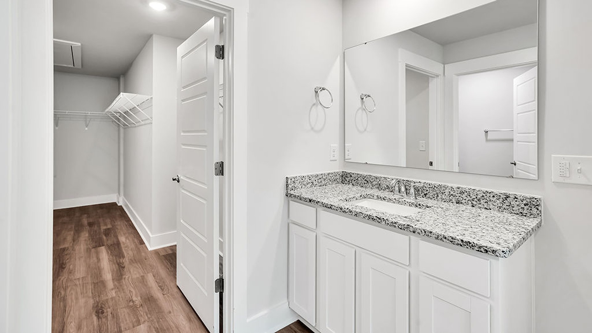 Adjacent to the entry area is Bedroom 2, a versatile space that can serve as a guest room or home office. It has access to a full bathroom situated next to the laundry room.
