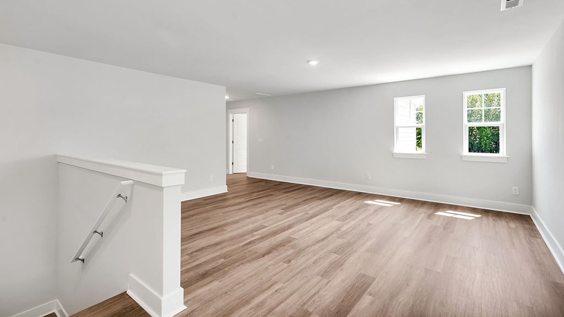 Adjacent to the entry area is Bedroom 2, a versatile space that can serve as a guest room or home office. It has access to a full bathroom situated next to the laundry room.