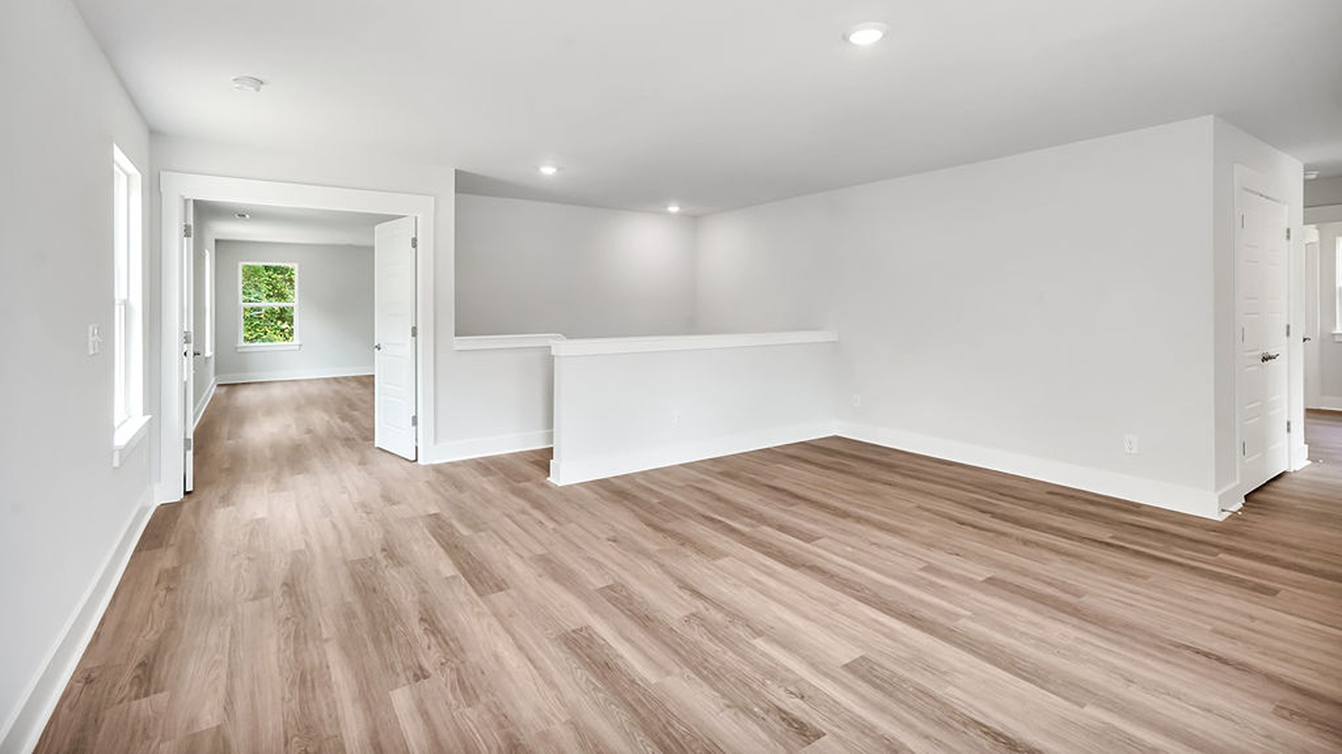 Adjacent to the entry area is Bedroom 2, a versatile space that can serve as a guest room or home office. It has access to a full bathroom situated next to the laundry room.