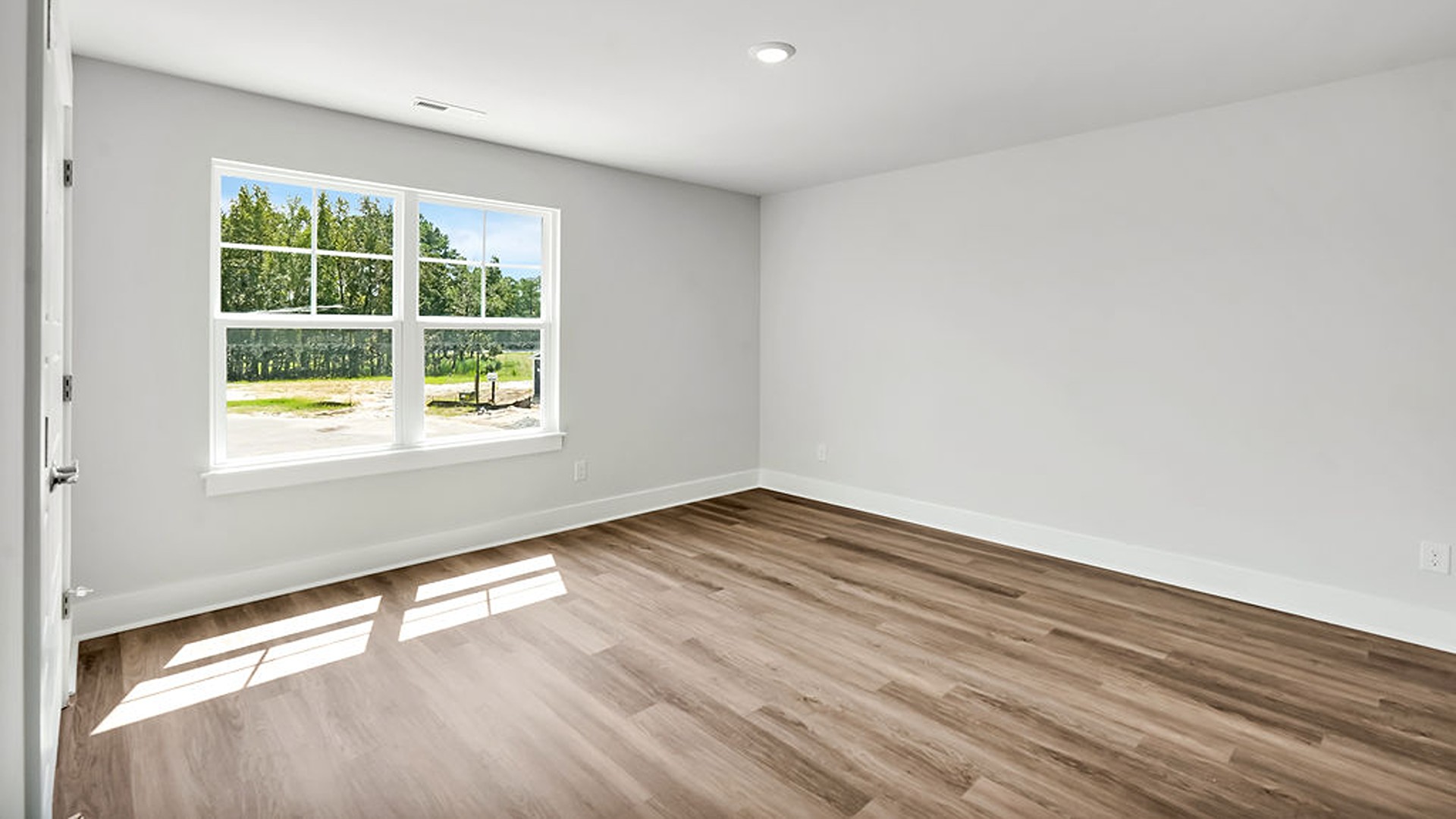 Adjacent to the entry area is Bedroom 2, a versatile space that can serve as a guest room or home office. It has access to a full bathroom situated next to the laundry room.