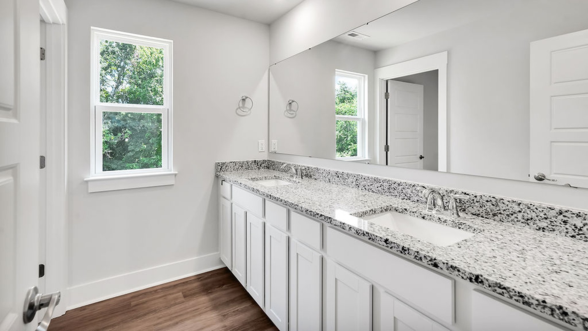 The Guilford second story provides a private living area separate from the main floor, which includes a large upstairs living room, the Primary Bedroom suite, and three additional bedrooms with shared access to bathrooms and laundry facilities