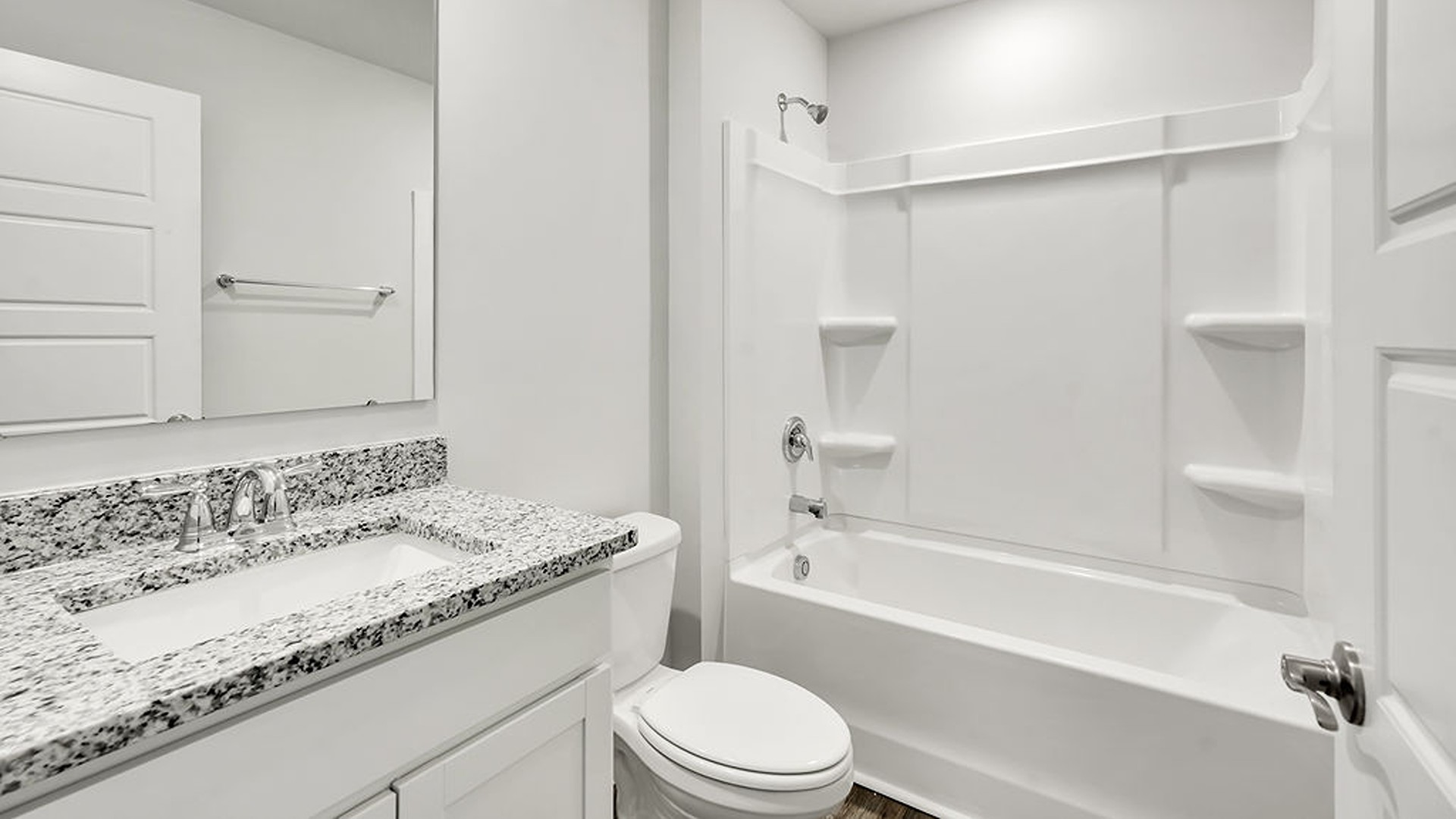 Adjacent to the entry area is Bedroom 2, a versatile space that can serve as a guest room or home office. It has access to a full bathroom situated next to the laundry room.