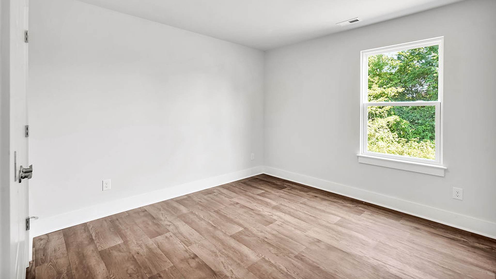 Adjacent to the entry area is Bedroom 2, a versatile space that can serve as a guest room or home office. It has access to a full bathroom situated next to the laundry room.