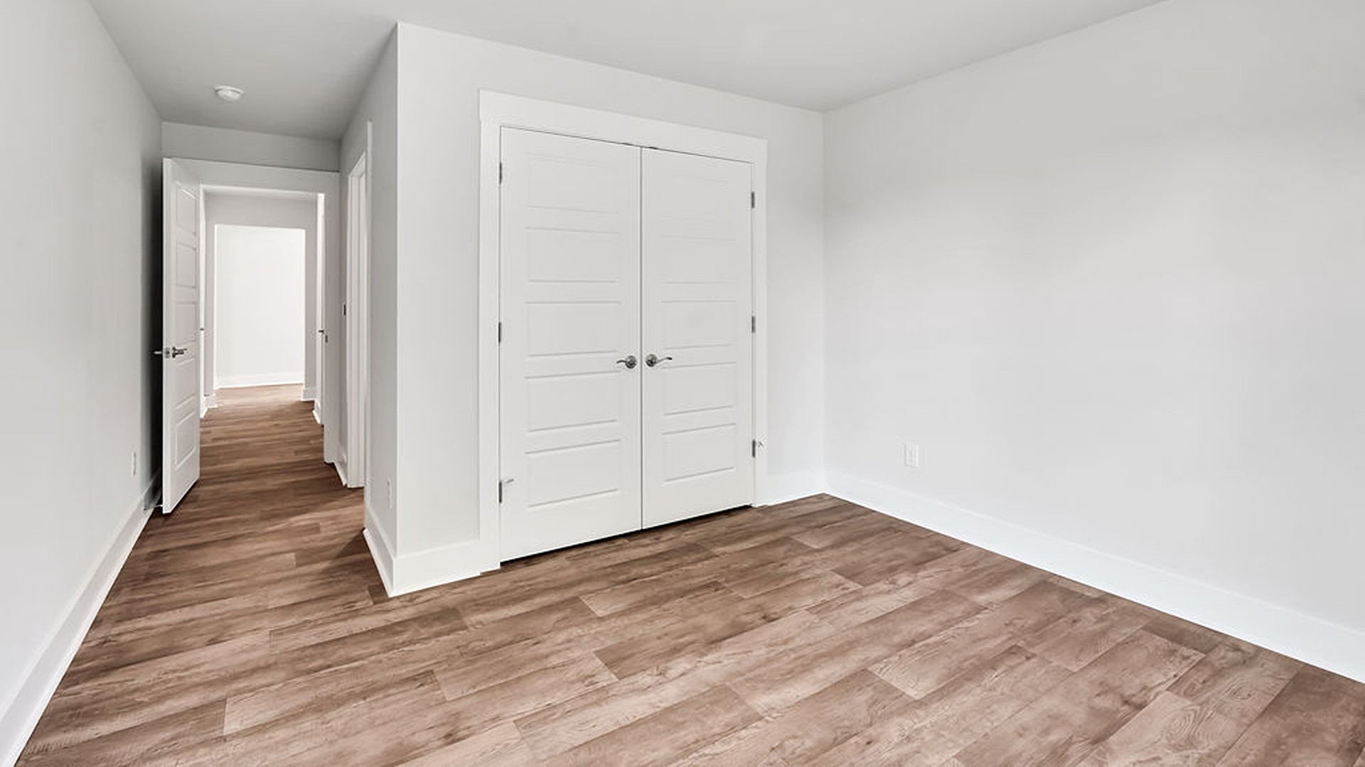 Adjacent to the entry area is Bedroom 2, a versatile space that can serve as a guest room or home office. It has access to a full bathroom situated next to the laundry room.