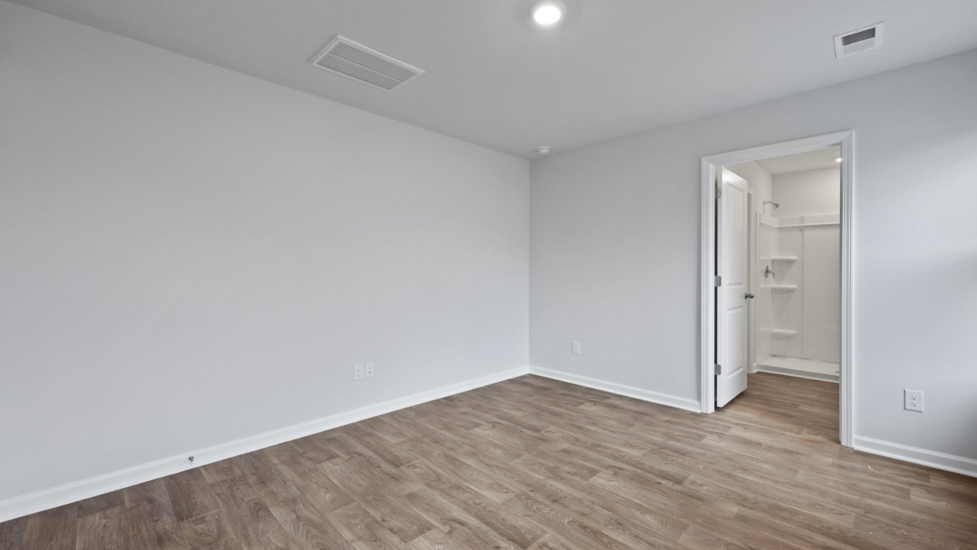 Bedroom One, located at the back of the house for privacy, also has a suite bathroom with double vanity and walk-in closet.