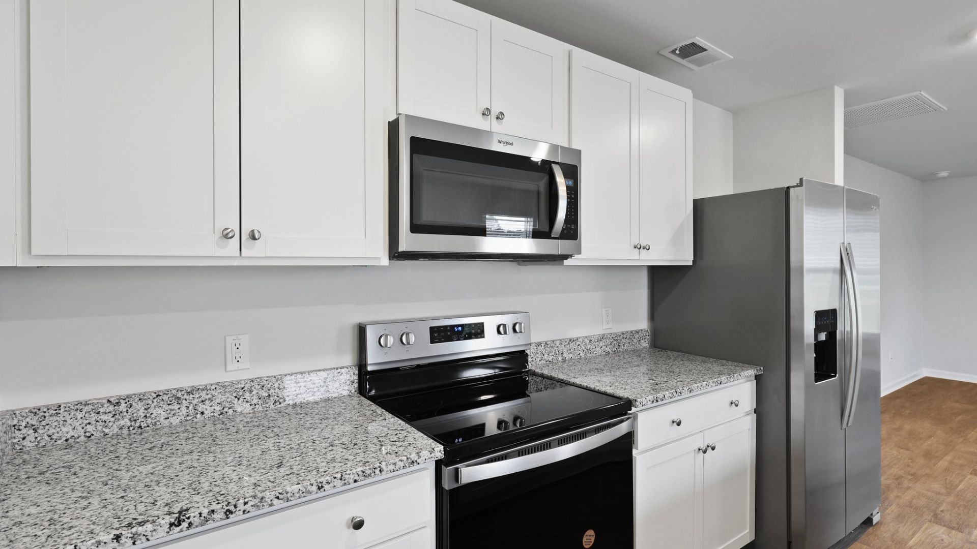 The kitchen features shaker-style cabinets, granite countertops, and stainless-steel appliances, which are sure to both turn heads and make meal prep easy. You’ll never be too far from the action with the living and dining area right there.  The primary bedroom has its own attached b