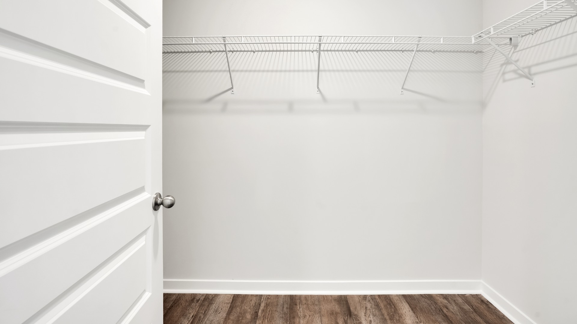 Two other bedrooms share a second bathroom. The laundry room is located at the front of home near the two-car garage