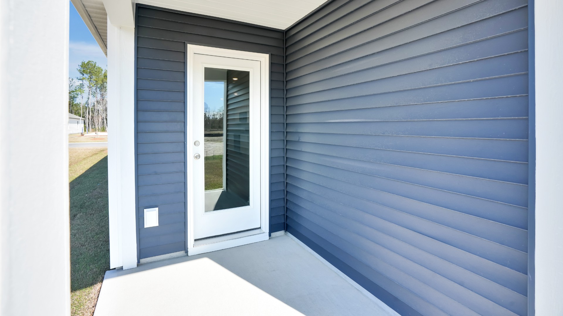 The living room overlooks a covered patio perfect for relaxing and entertaining outdoors.