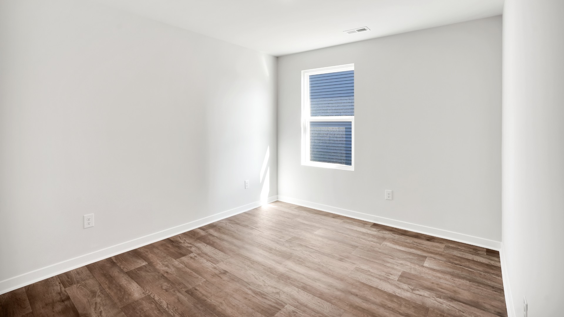 Two other bedrooms share a second bathroom. The laundry room is located at the front of home near the two-car garage