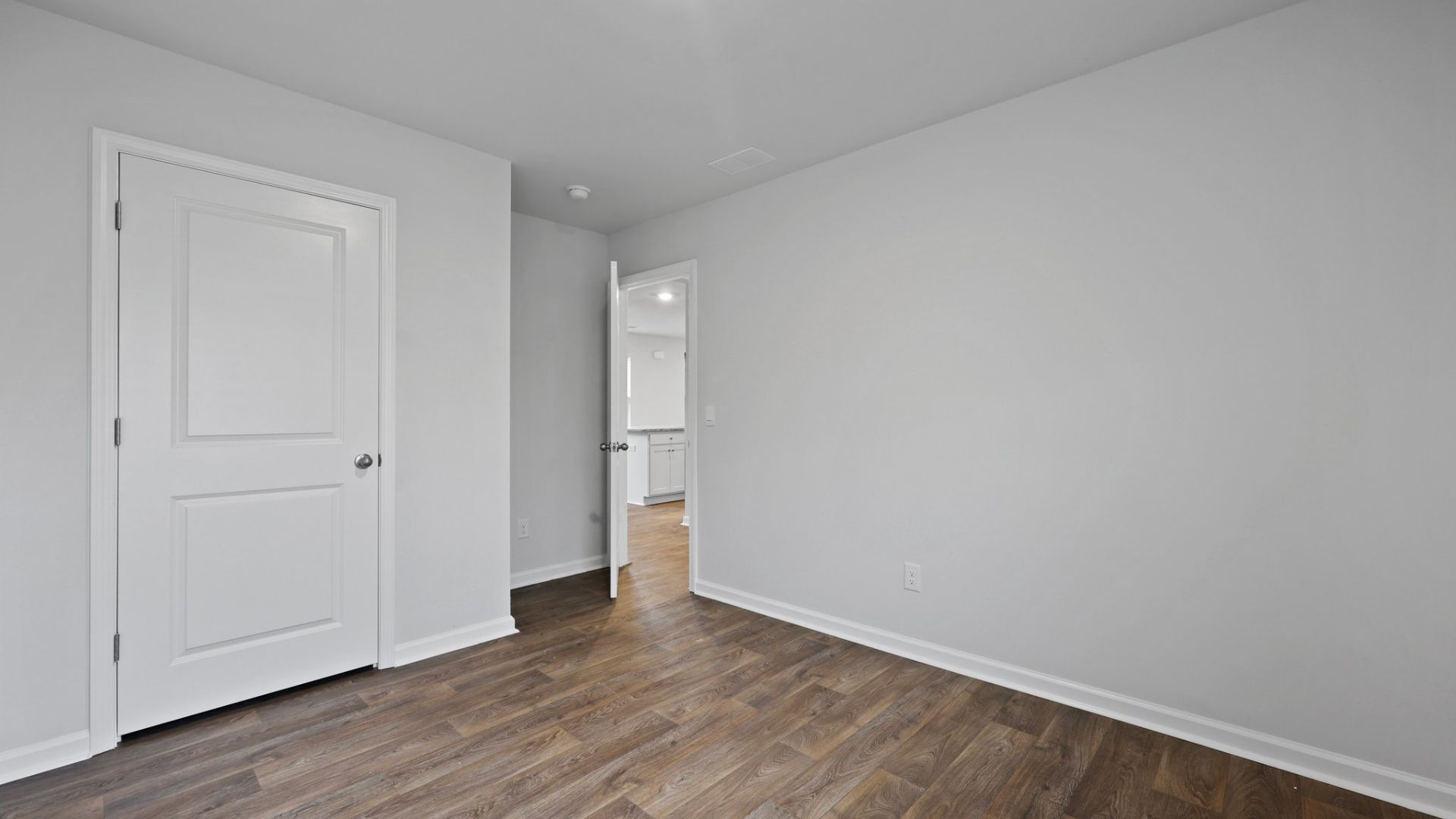 Two other bedrooms share a second bathroom. The laundry room is located at the front of home near the two-car garage, quietly away from living areas and bedrooms. Small covered porch at the front.