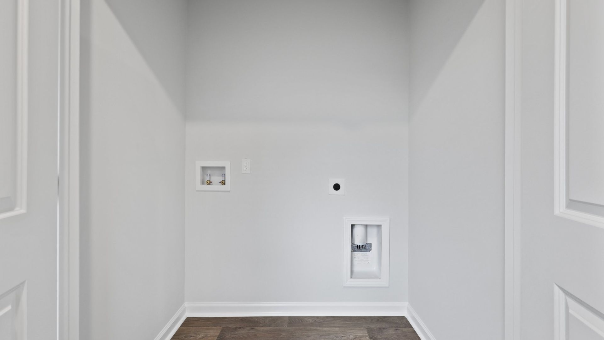 Two other bedrooms share a second bathroom. The laundry room is located at the front of home near the two-car garage, quietly away from living areas and bedrooms. Small covered porch at the front.