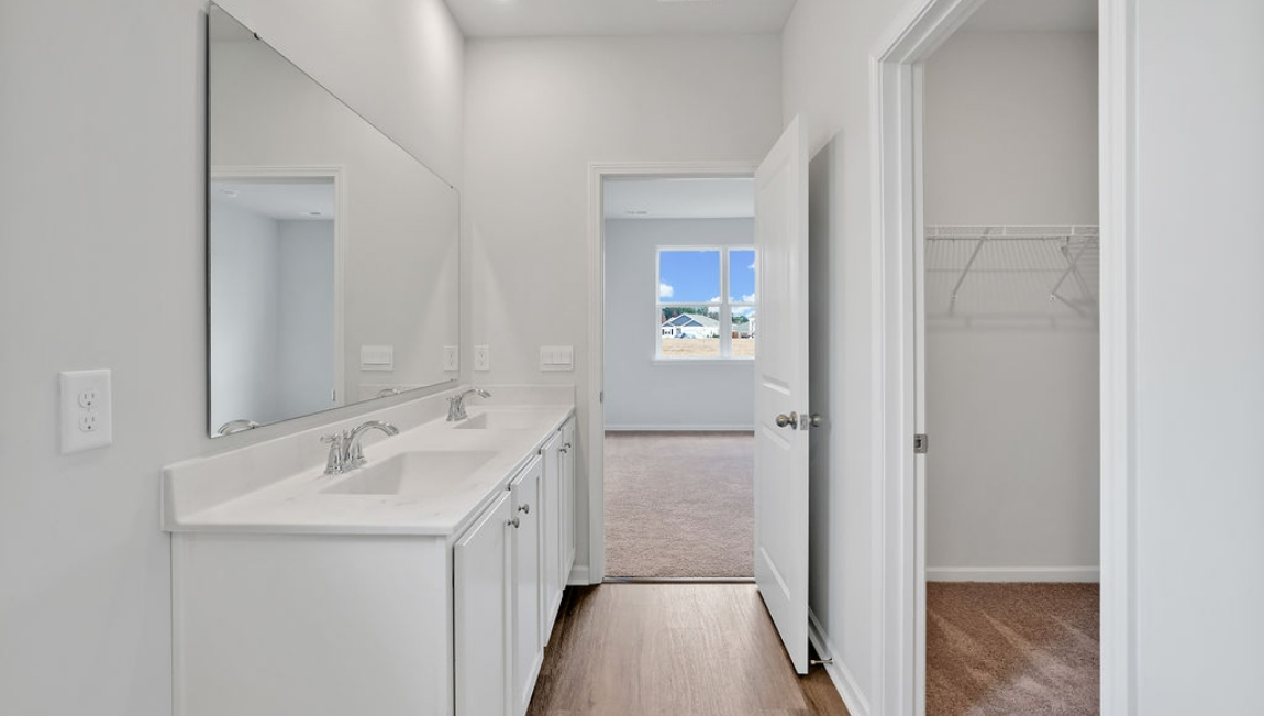 The primary bedroom has its own attached bathroom that features a walk-in closet and all the space you need to get ready in the morning