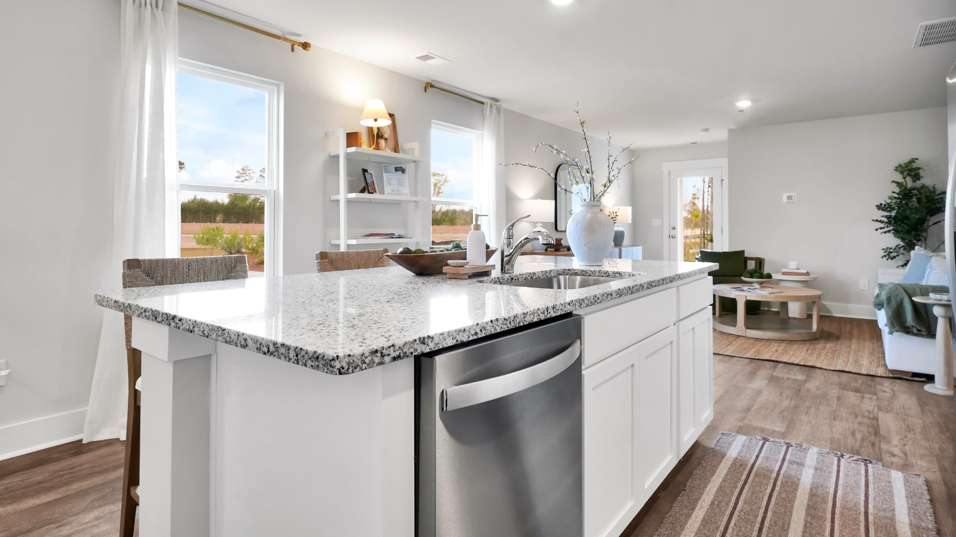 The kitchen features shaker-style cabinets, granite countertops, and stainless-steel appliances, which are sure to both turn heads and make meal prep easy. You’ll never be too far from the action with the living and dining area right there.