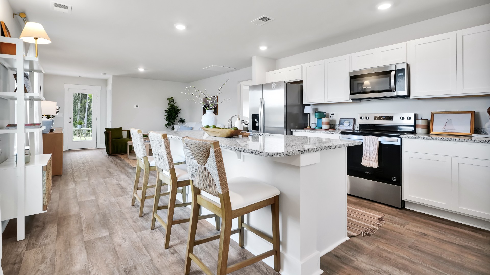 The kitchen features shaker-style cabinets, granite countertops, and stainless-steel appliances, which are sure to both turn heads and make meal prep easy. You’ll never be too far from the action with the living and dining area right there.