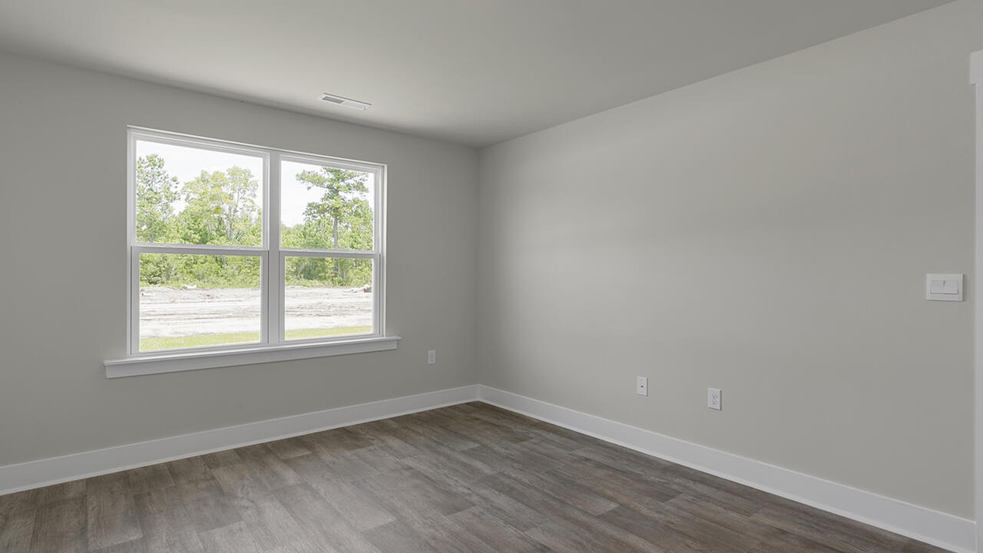 The primary suite is tucked away in the back of the home, offering a peaceful retreat complete with a walk-in shower (glass door included!), granite vanity, and a roomy walk-in closet.