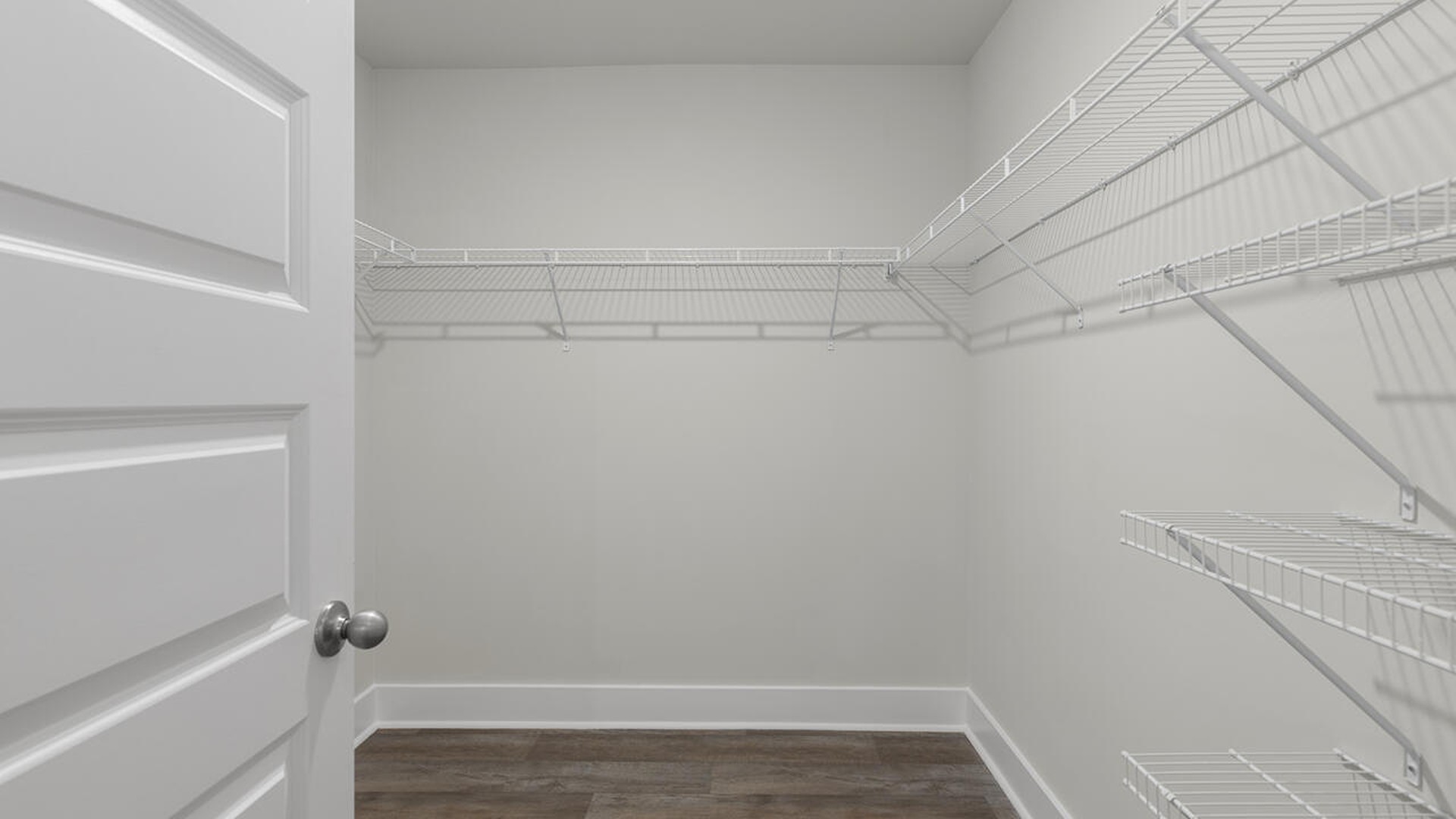 The primary suite is tucked away in the back of the home, offering a peaceful retreat complete with a walk-in shower (glass door included!), granite vanity, and a roomy walk-in closet.