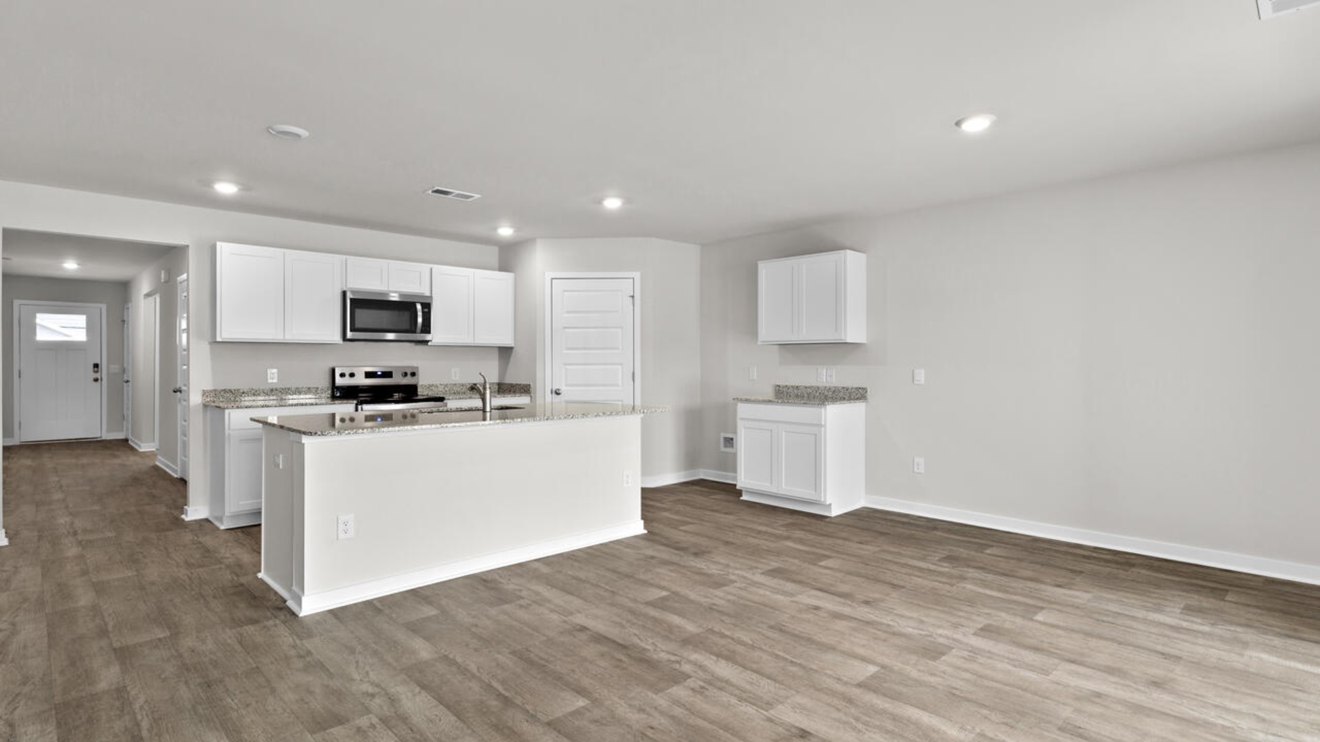 The kitchen is a showstopper with granite countertops, stainless steel appliances, and a big island perfect for entertaining or casual meals. You’ll never be too far from the action with the living and dining area right there.