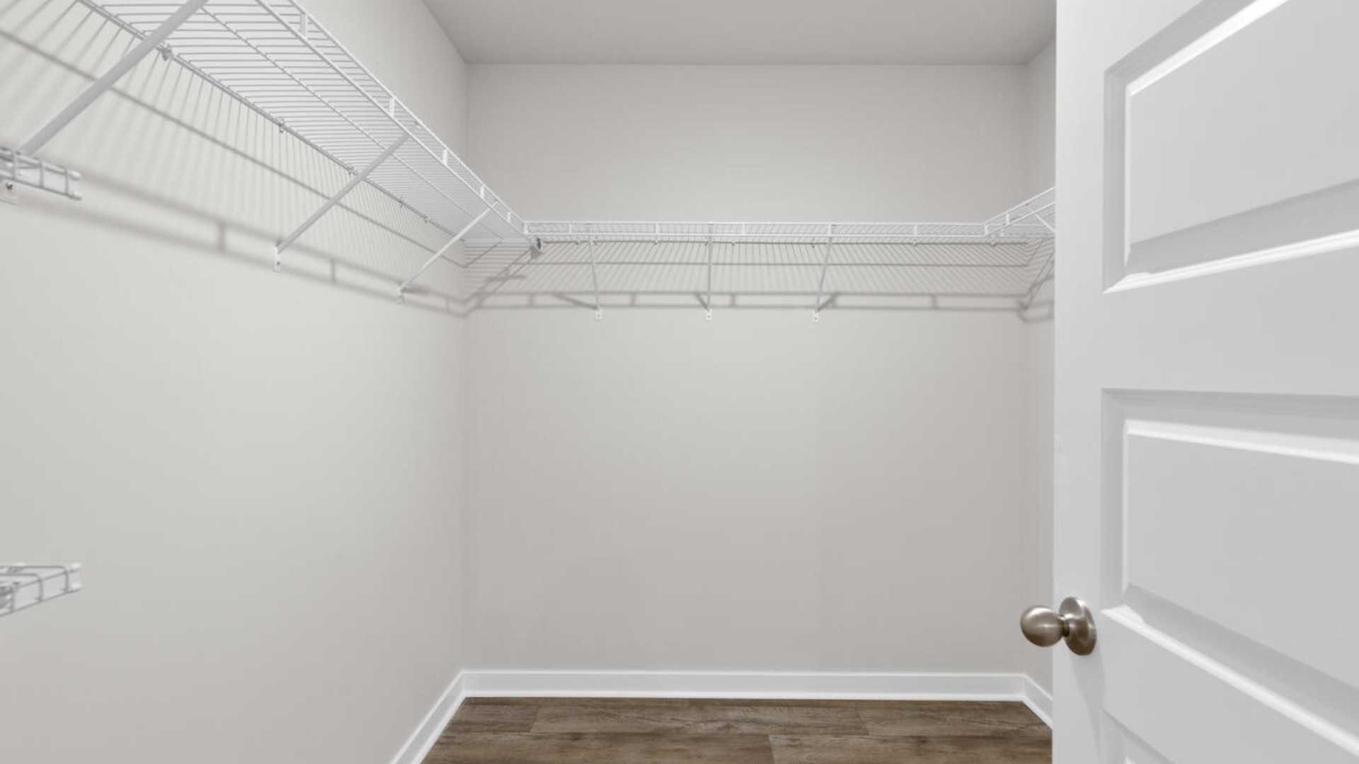 The primary suite is tucked away in the back of the home, offering a peaceful retreat complete with a walk-in shower (glass door included!), granite vanity, and a roomy walk-in closet.