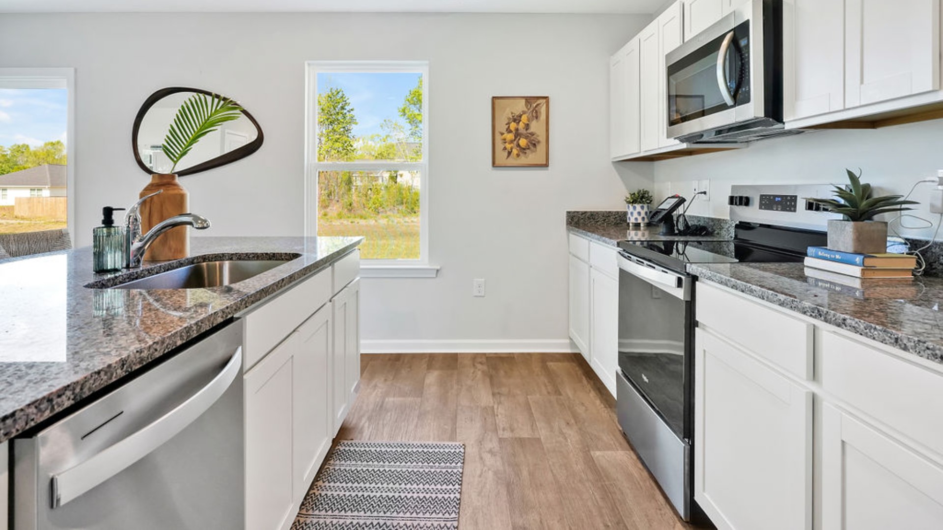 . Its open-concept design includes a kitchen with granite countertops and stainless steel appliances, an island, and a walk-in pantry, while the large Great Room is ideal for entertaining.