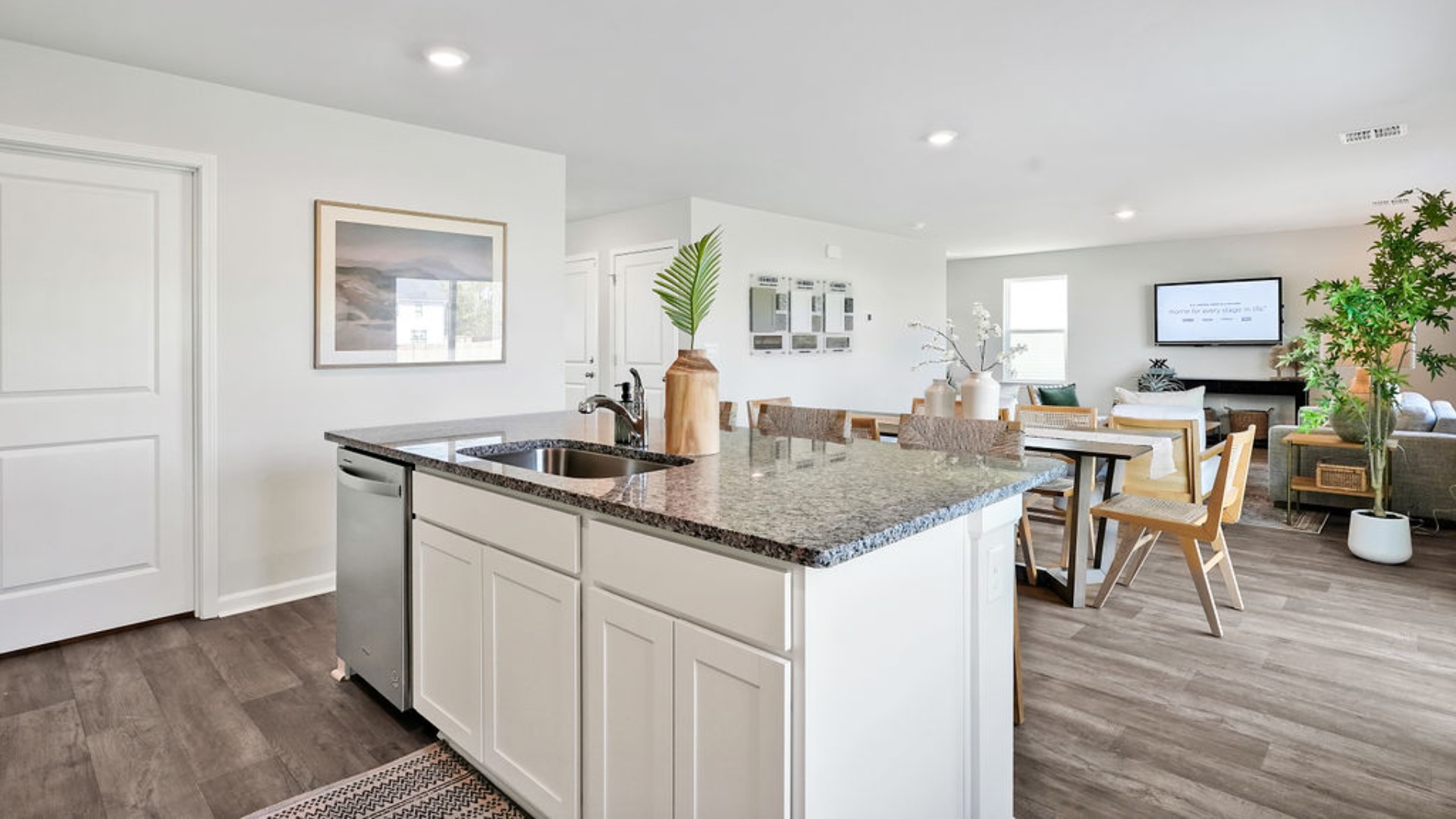 . Its open-concept design includes a kitchen with granite countertops and stainless steel appliances, an island, and a walk-in pantry, while the large Great Room is ideal for entertaining.