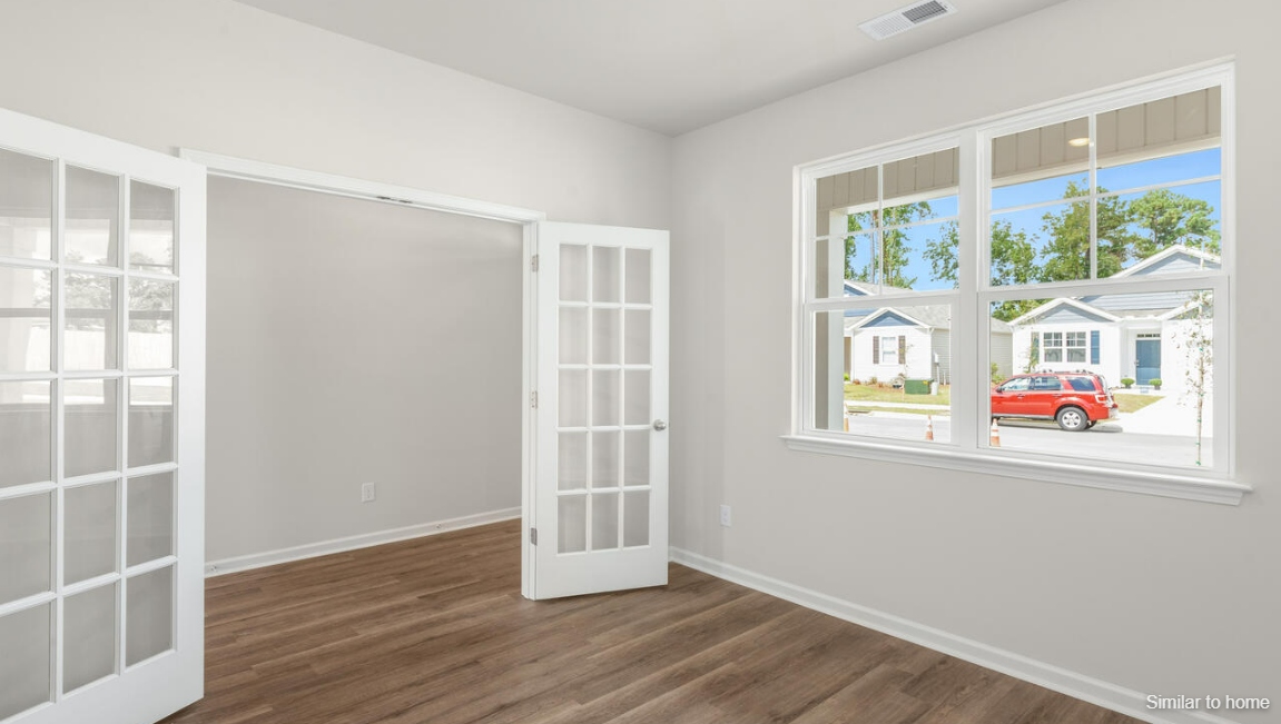 Designed for modern living, the main level features a flexible front room that can serve as a formal dining area, home office, or sitting room.