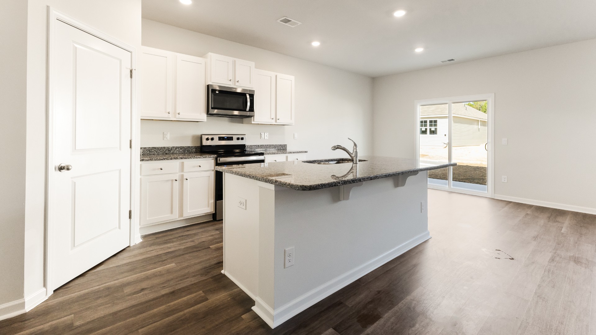 The kitchen features beautiful cabinets, granite countertops, and stainless steel appliances, which are sure to both turn heads and make meal prep easy. You’ll never be too far from the action with the living and dining area right there.