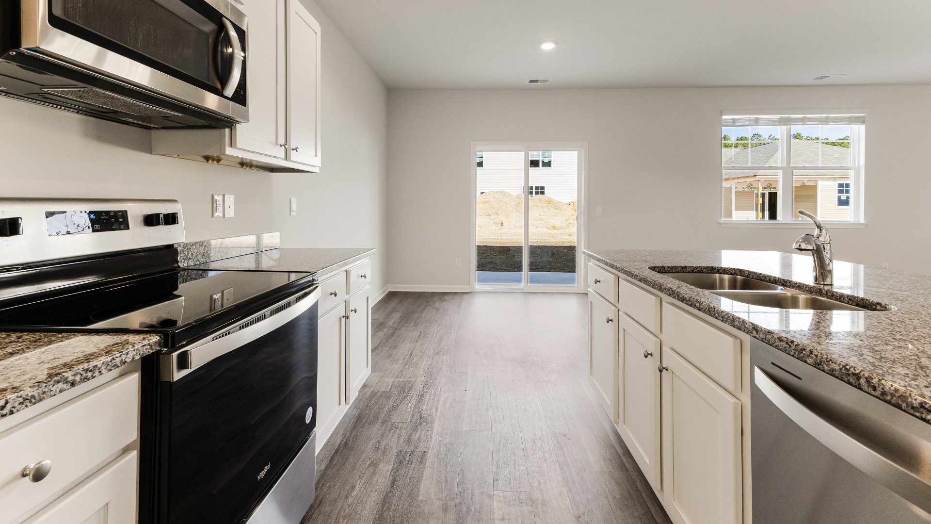 The kitchen features beautiful cabinets, granite countertops, and stainless steel appliances, which are sure to both turn heads and make meal prep easy. You’ll never be too far from the action with the living and dining area right there.