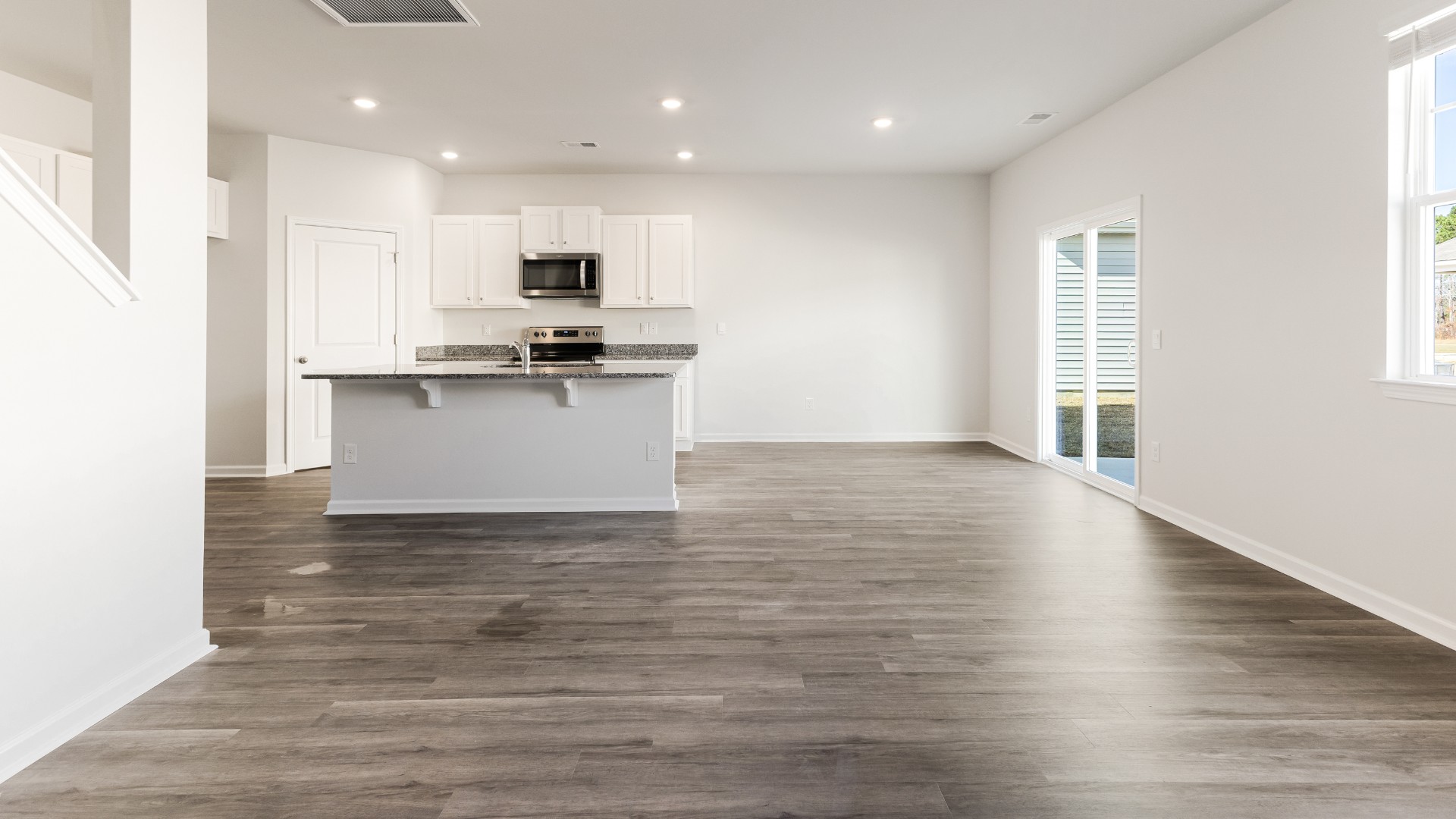 The kitchen features beautiful cabinets, granite countertops, and stainless steel appliances, which are sure to both turn heads and make meal prep easy. You’ll never be too far from the action with the living and dining area right there.