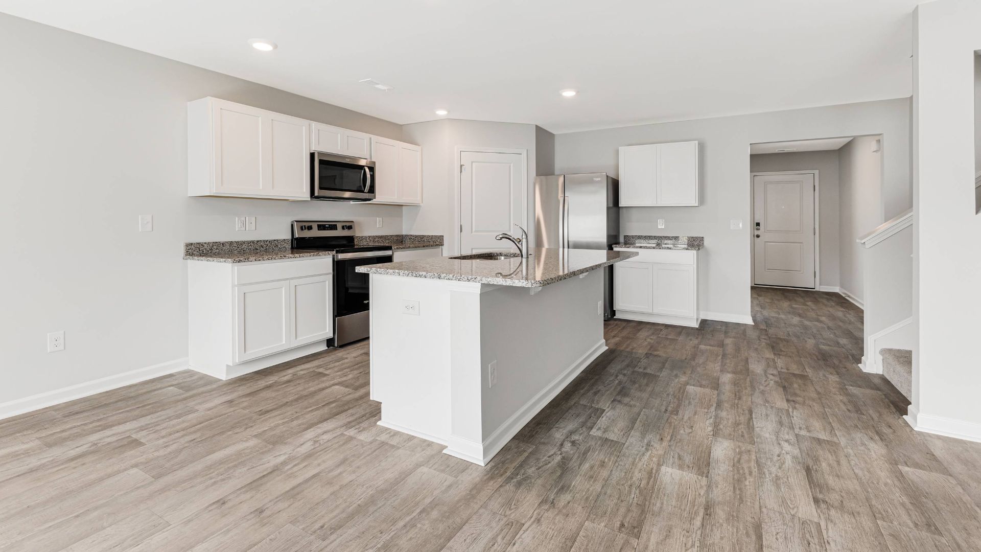 The kitchen features beautiful cabinets, granite countertops, and stainless steel appliances, which are sure to both turn heads and make meal prep easy. You’ll never be too far from the action with the living and dining area right there.