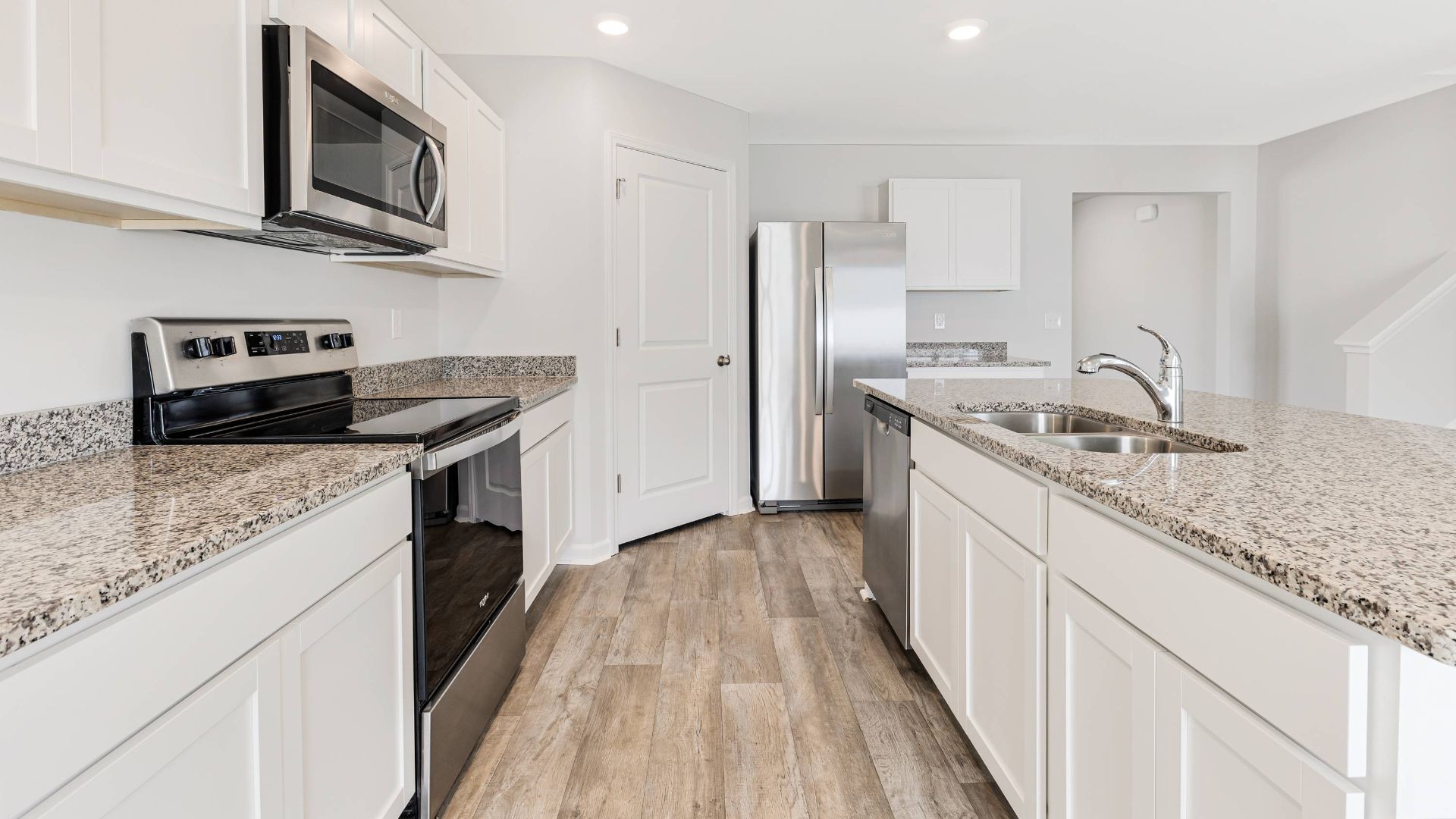 The kitchen features beautiful cabinets, granite countertops, and stainless steel appliances, which are sure to both turn heads and make meal prep easy. You’ll never be too far from the action with the living and dining area right there.