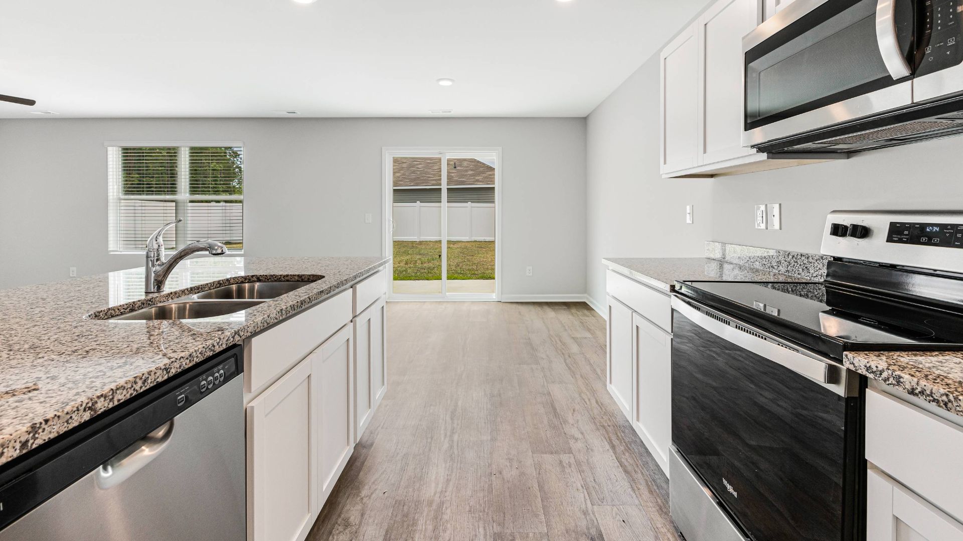 The kitchen features beautiful cabinets, granite countertops, and stainless steel appliances, which are sure to both turn heads and make meal prep easy. You’ll never be too far from the action with the living and dining area right there.