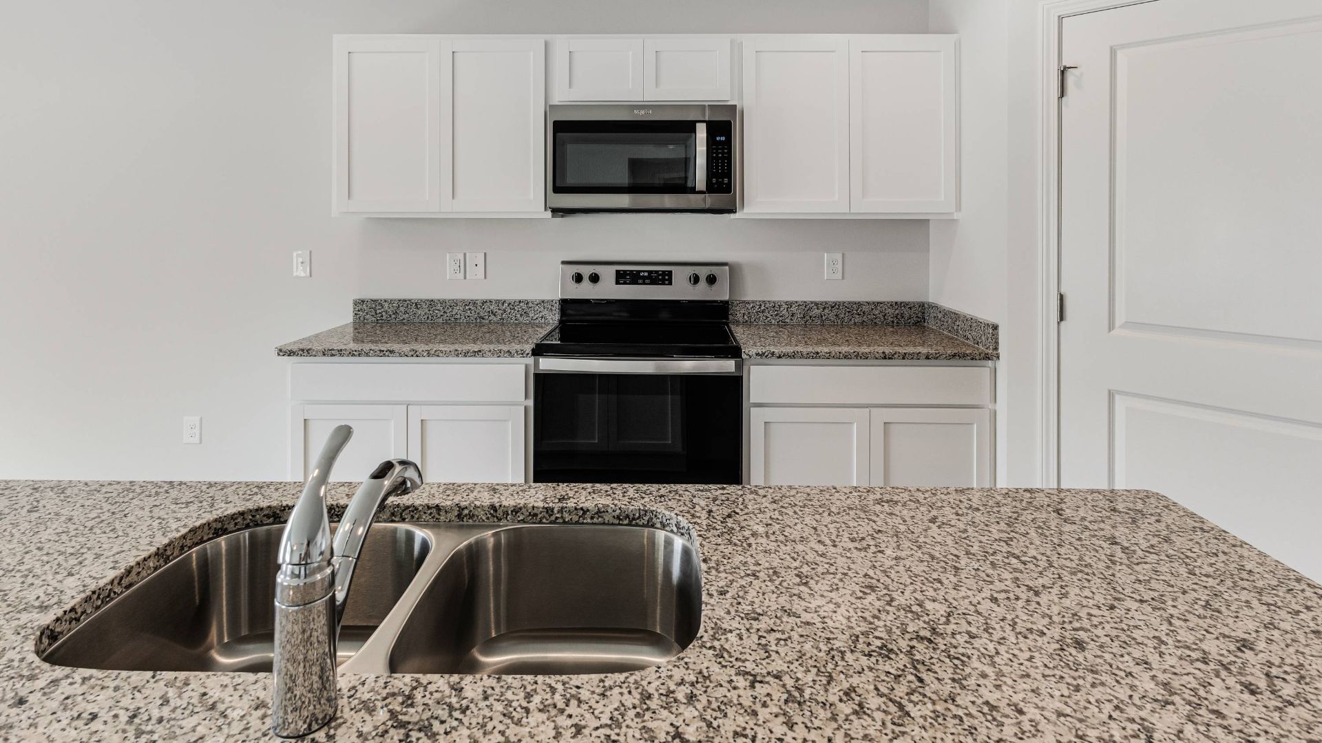 The kitchen features beautiful cabinets, granite countertops, and stainless steel appliances, which are sure to both turn heads and make meal prep easy. You’ll never be too far from the action with the living and dining area right there.