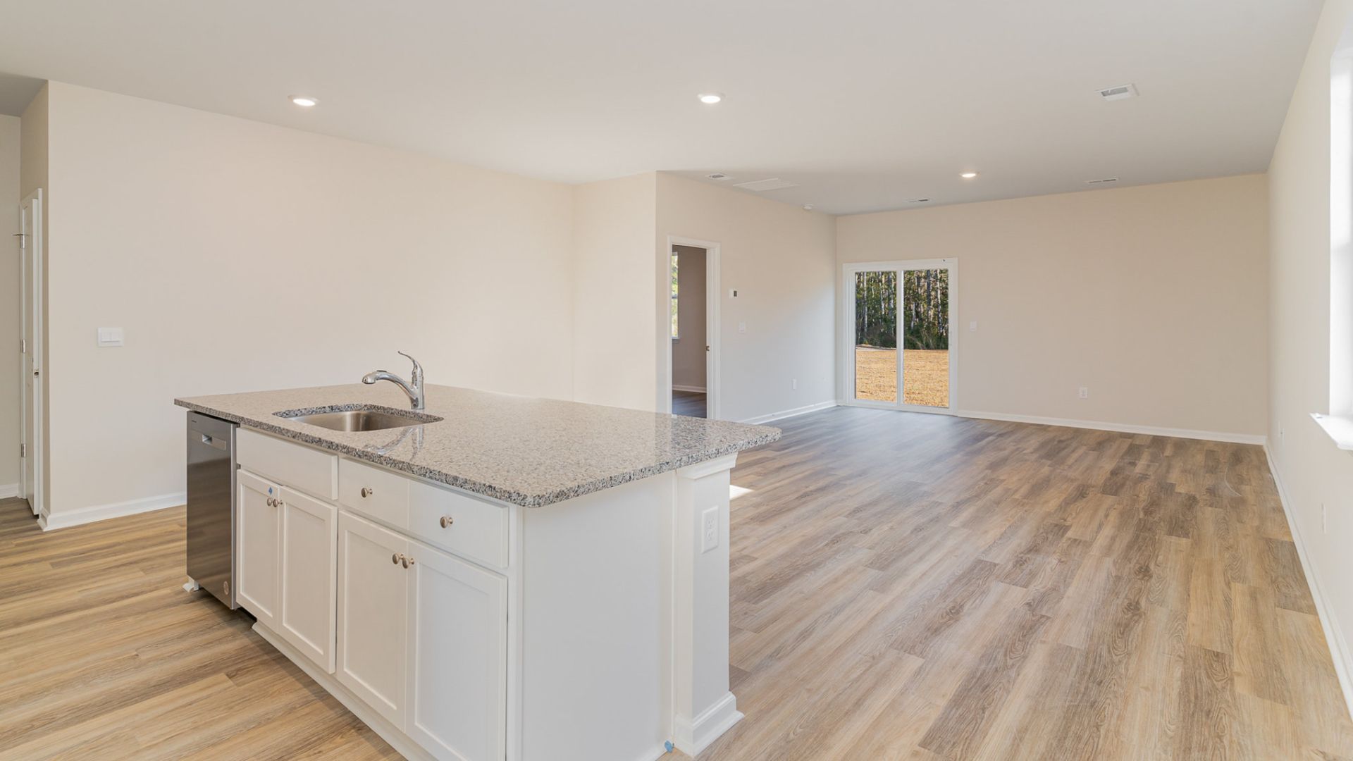 The kitchen features beautiful cabinets, granite countertops, and stainless steel appliances, which are sure to both turn heads and make meal prep easy. You’ll never be too far from the action with the living and dining area right there.