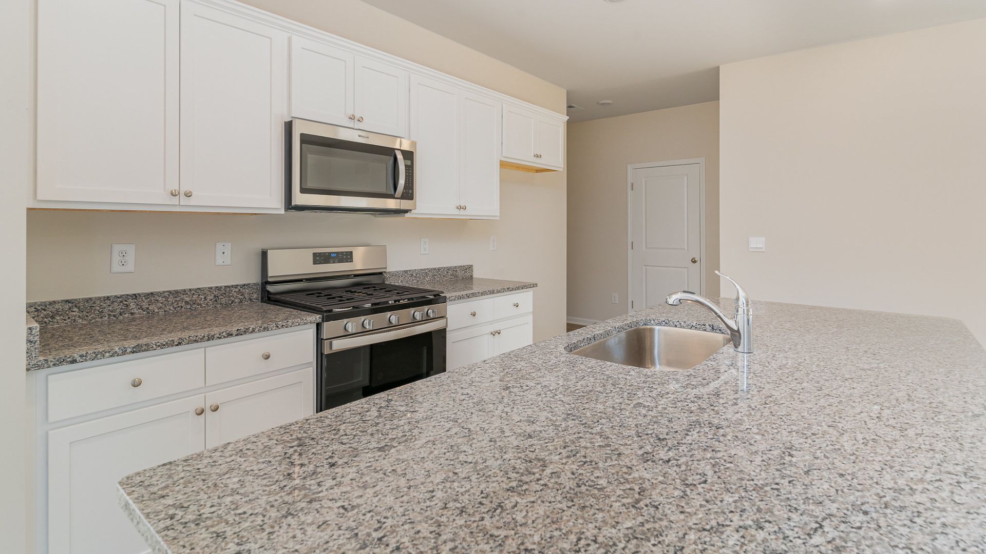 The kitchen features beautiful cabinets, granite countertops, and stainless steel appliances, which are sure to both turn heads and make meal prep easy. You’ll never be too far from the action with the living and dining area right there.