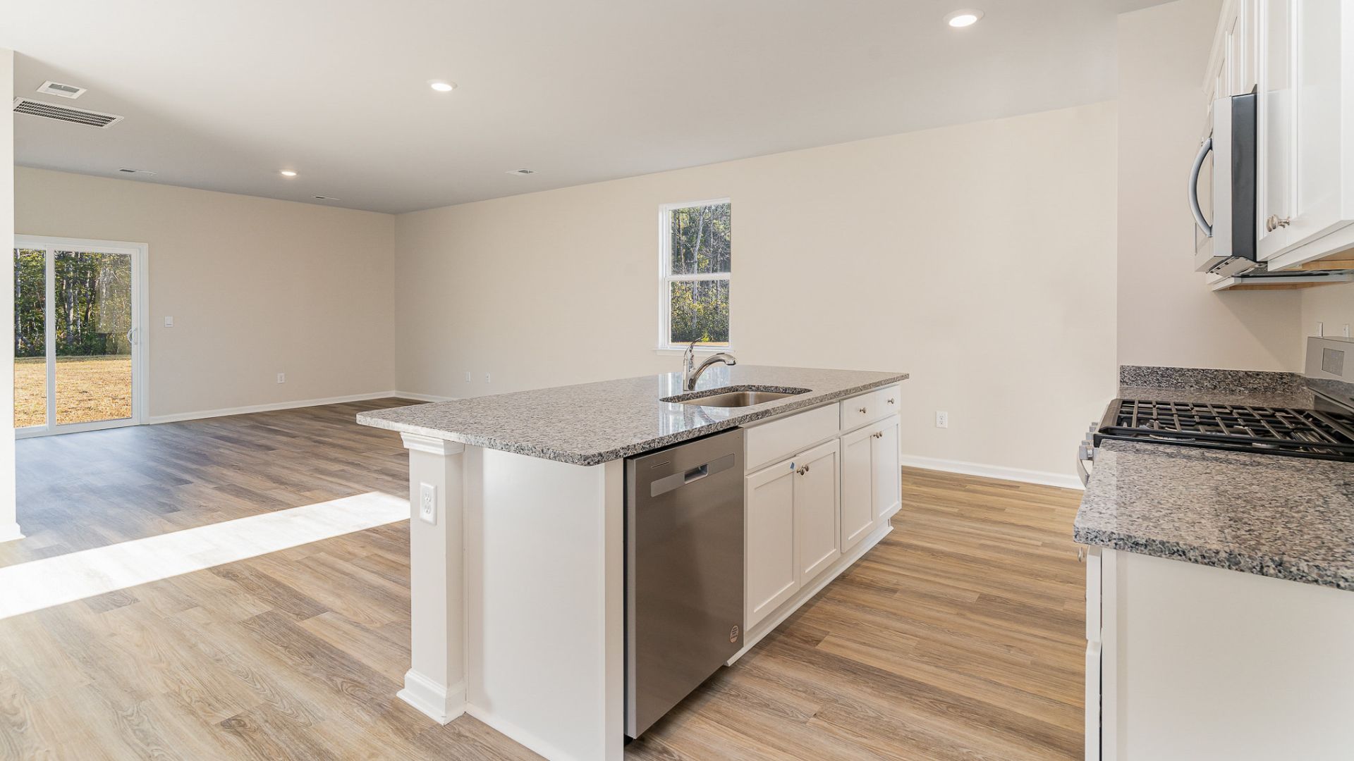 The kitchen features beautiful cabinets, granite countertops, and stainless steel appliances, which are sure to both turn heads and make meal prep easy. You’ll never be too far from the action with the living and dining area right there.