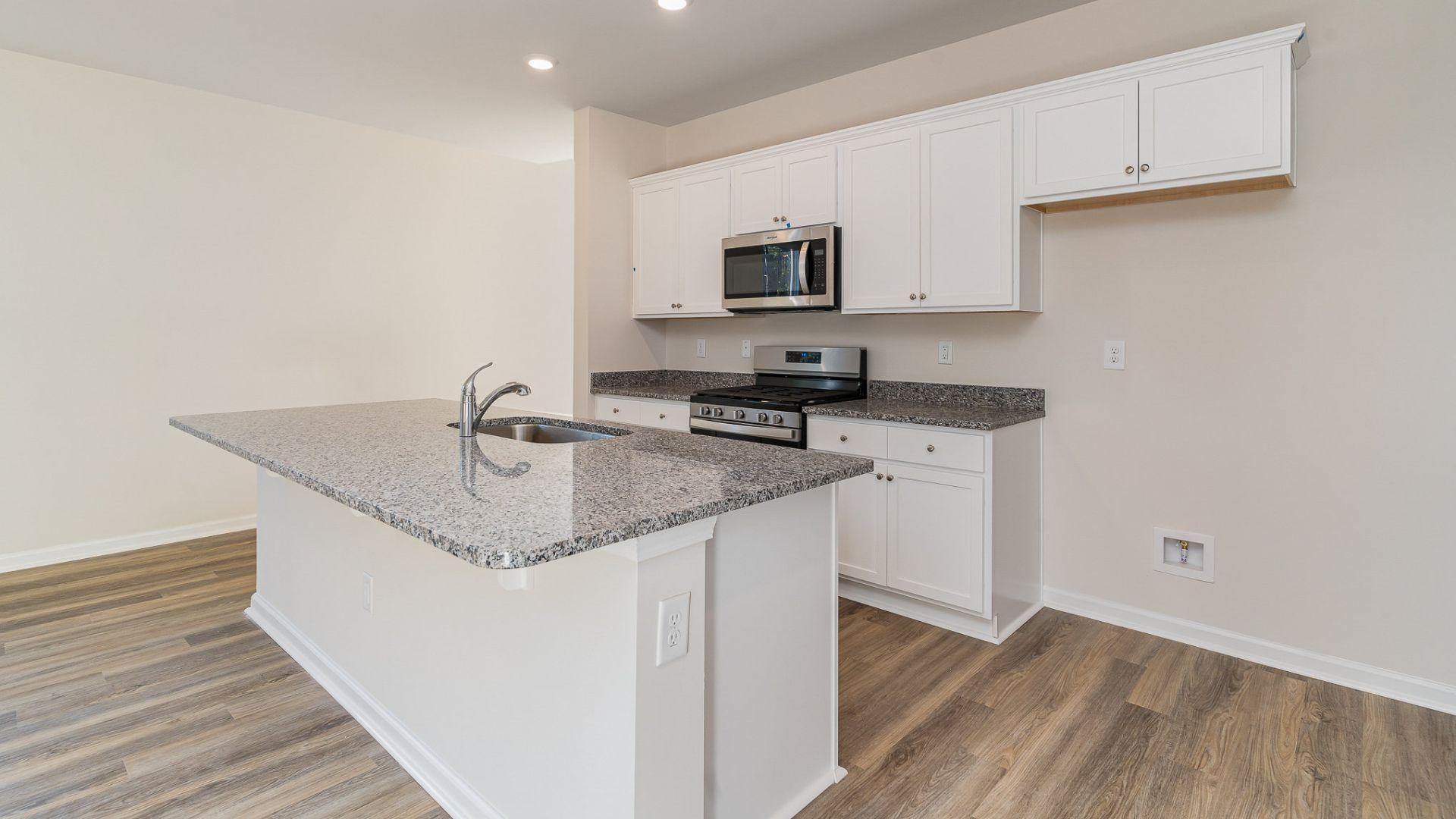 The kitchen features beautiful cabinets, granite countertops, and stainless steel appliances, which are sure to both turn heads and make meal prep easy. You’ll never be too far from the action with the living and dining area right there.