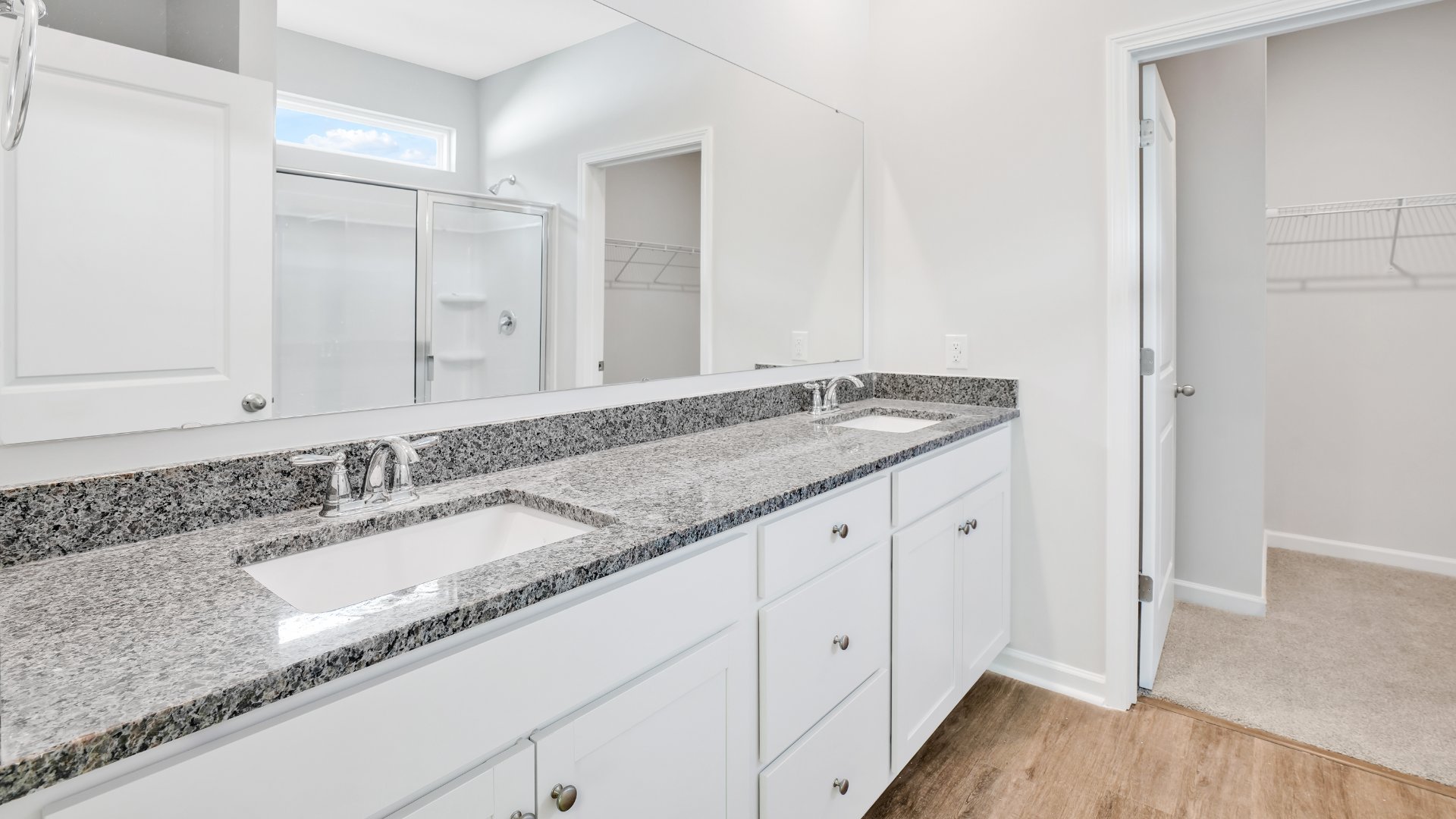 The primary bedroom is on the first floor and has its own attached bathroom that features a walk-in closet and all the space you need to get ready in the morning.